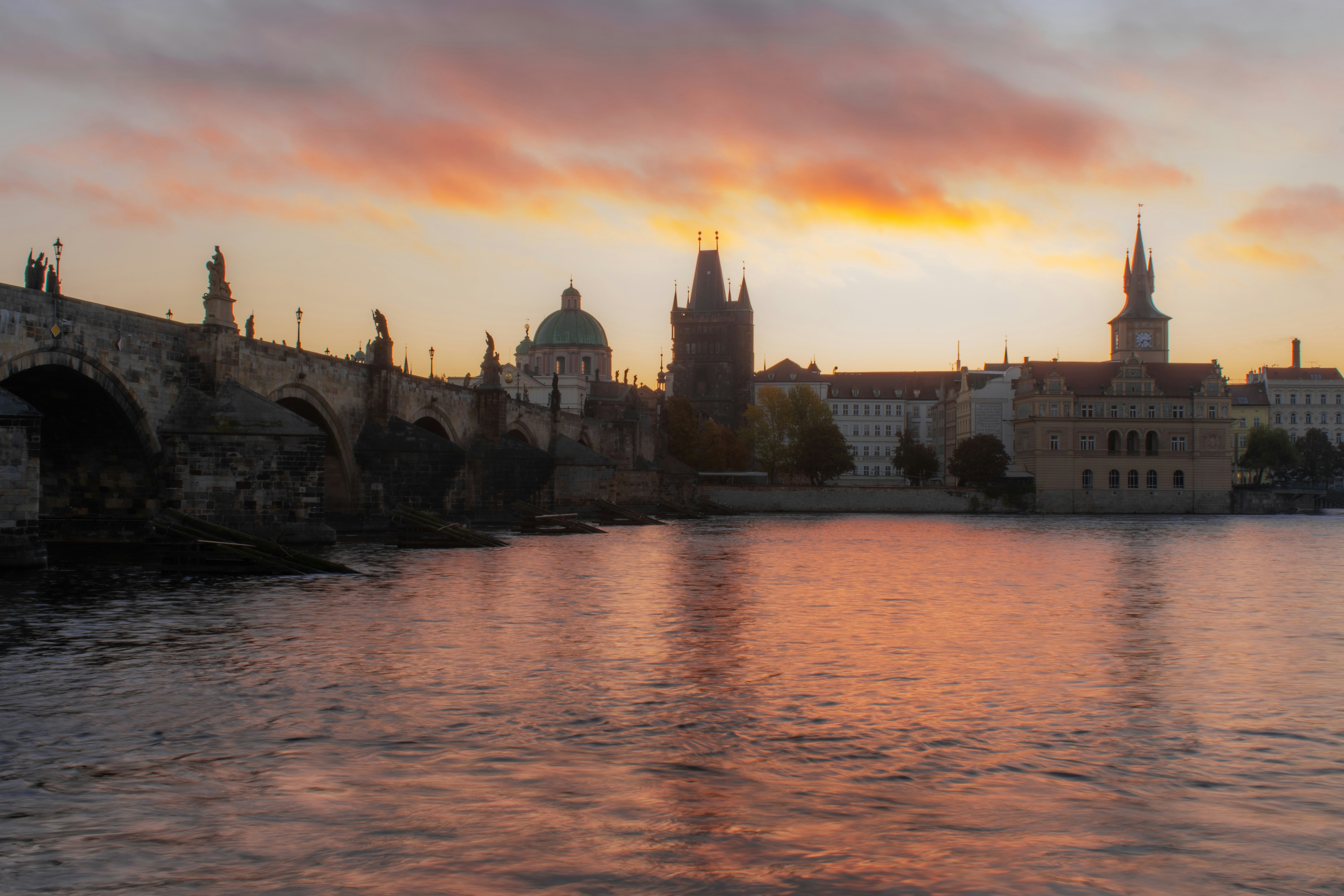 A river with a bridge and buildings in the background