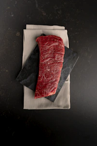 A piece of meat sitting on top of a napkin