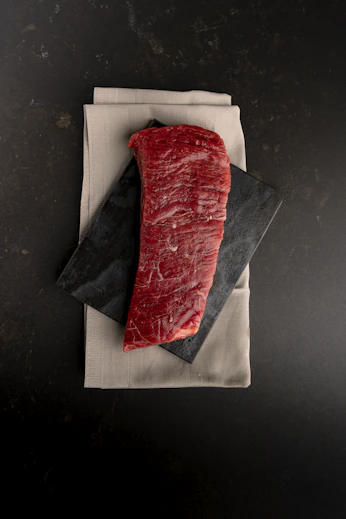 A piece of meat sitting on top of a napkin