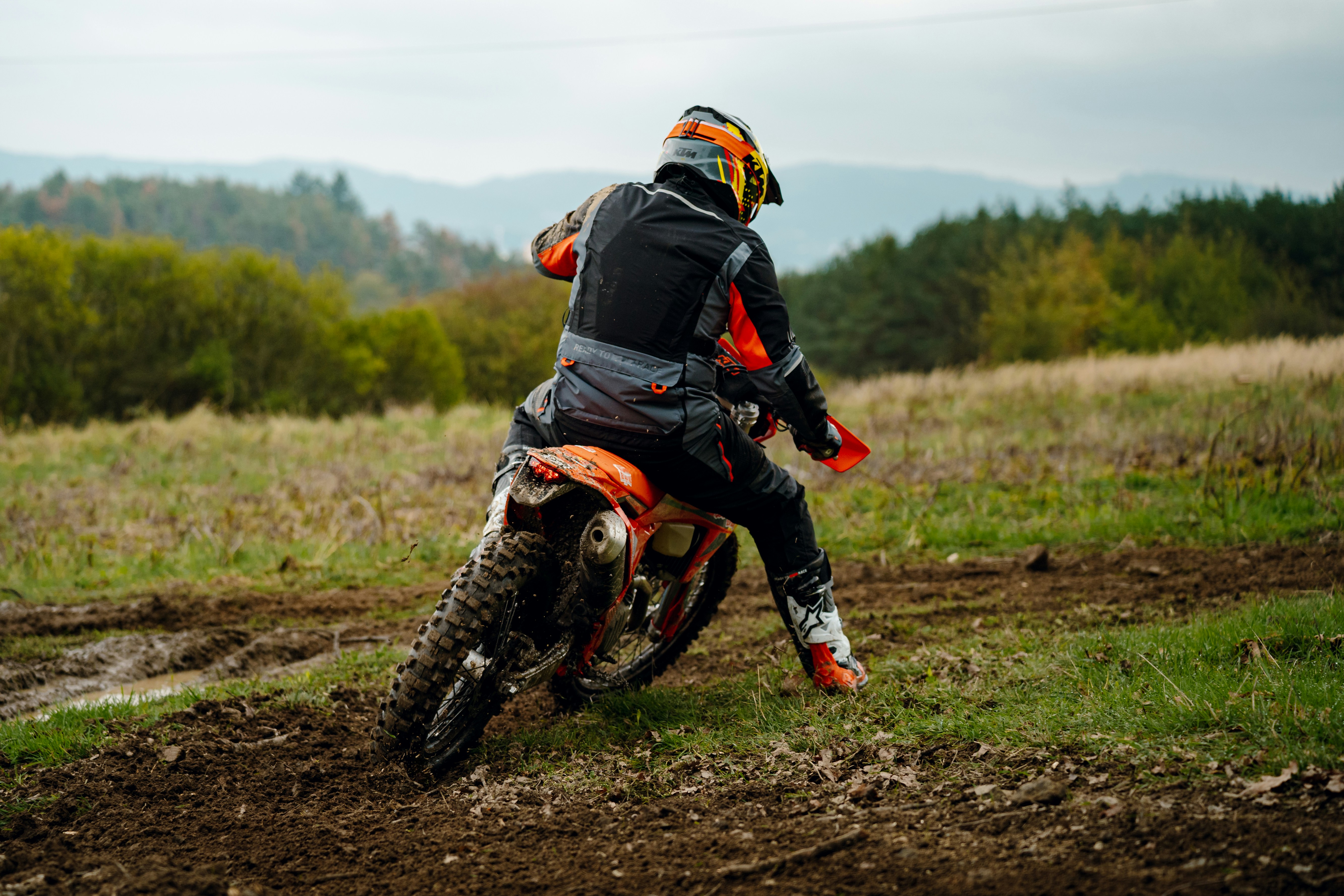 A man riding a dirt bike on top of a dirt field