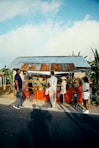 A group of people standing around a food stand