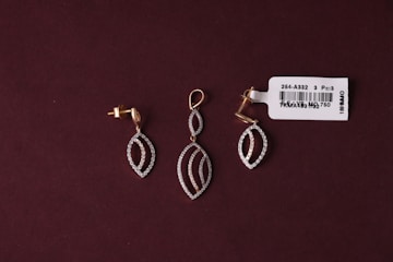 A pair of earrings sitting on top of a table