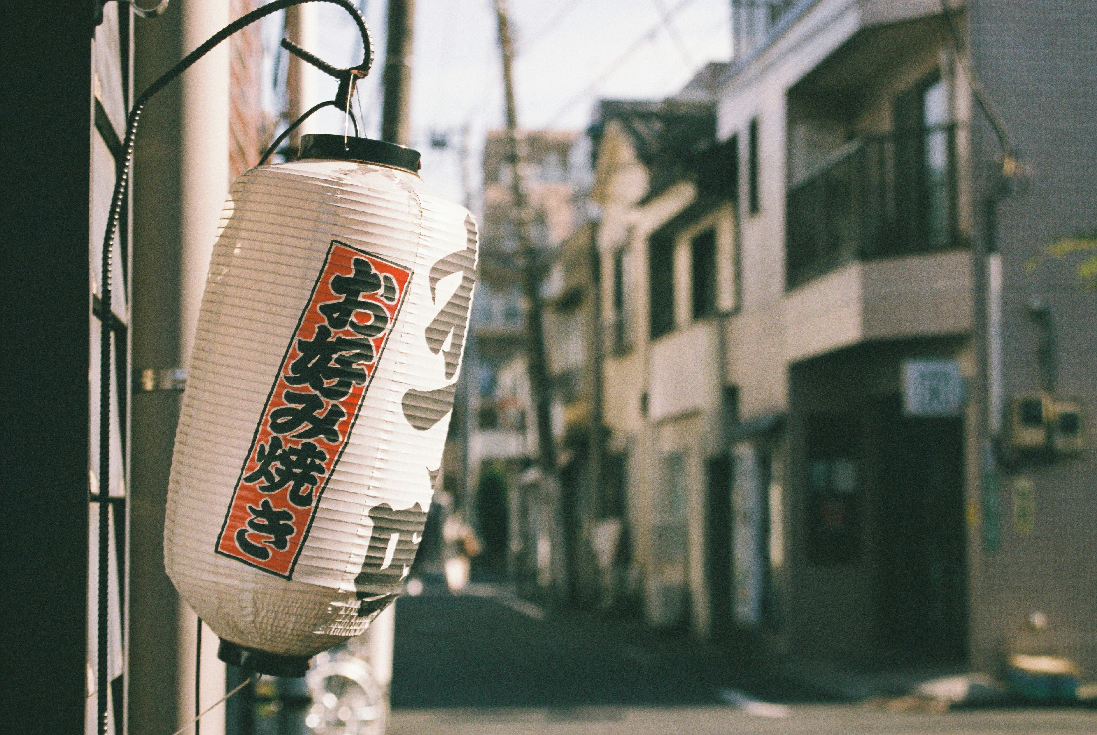 A lantern hanging from the side of a building