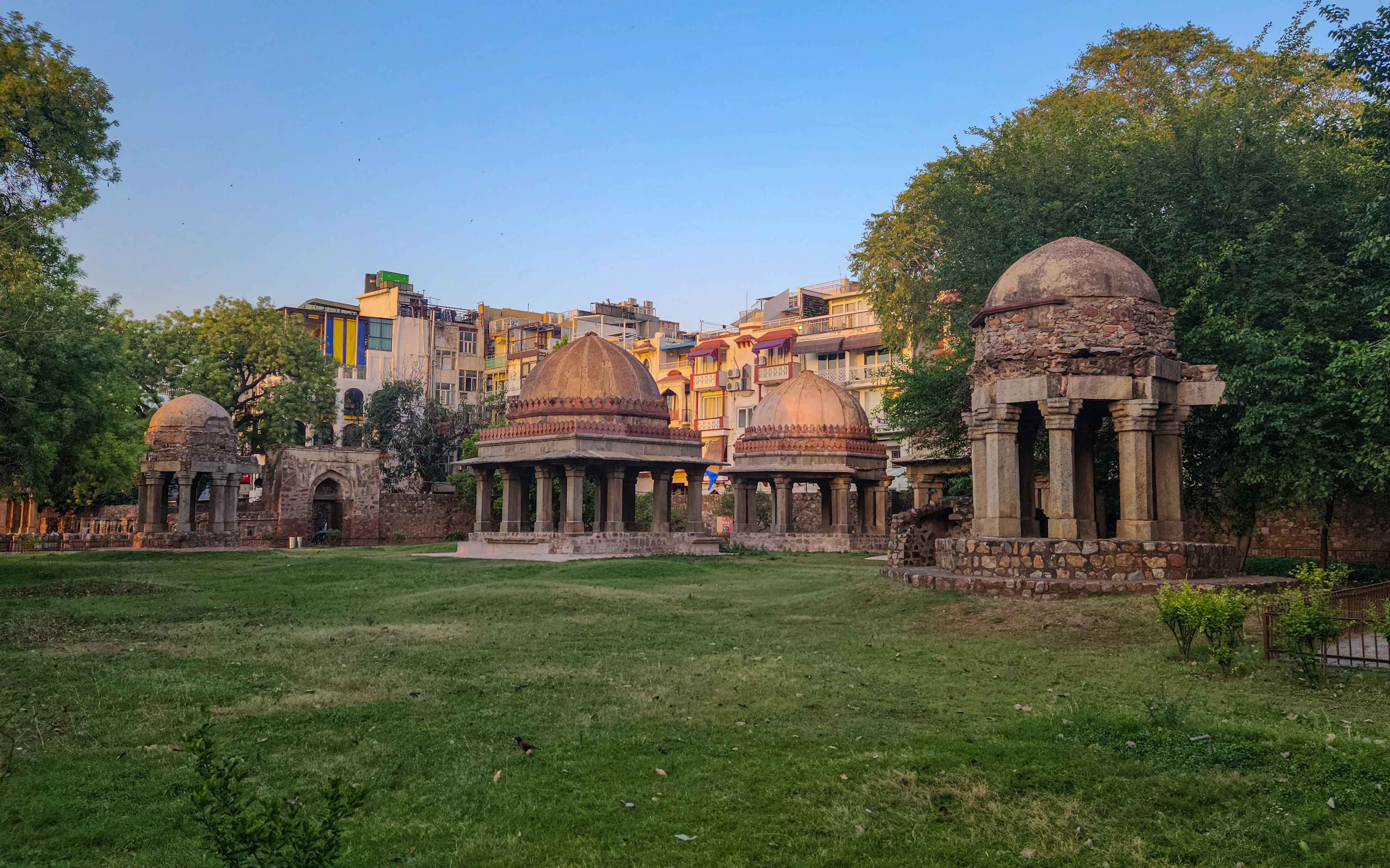 Domed pavilions of the Hauz Khas complex across a lawn