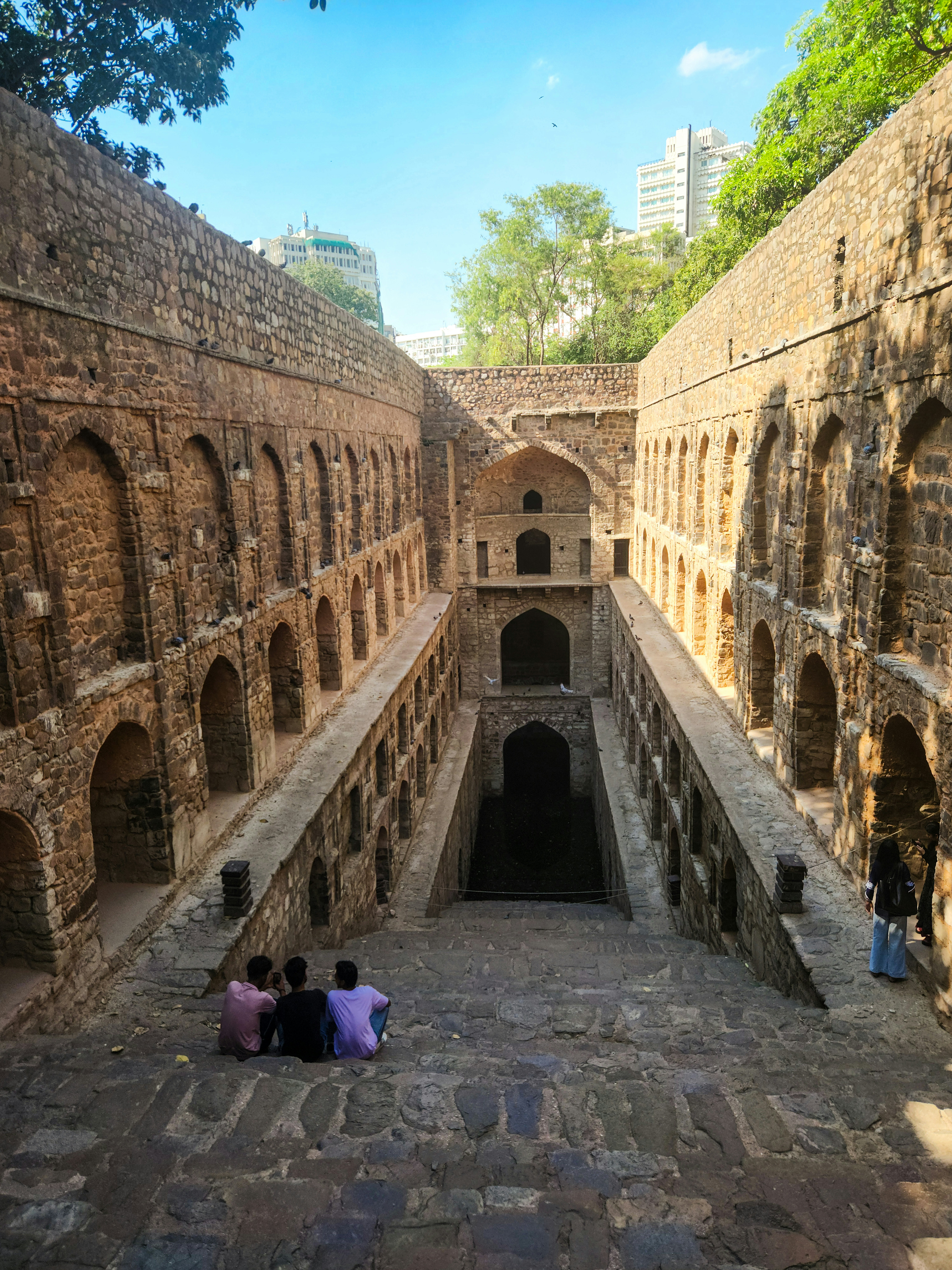 A group of people sitting on the floor of a building