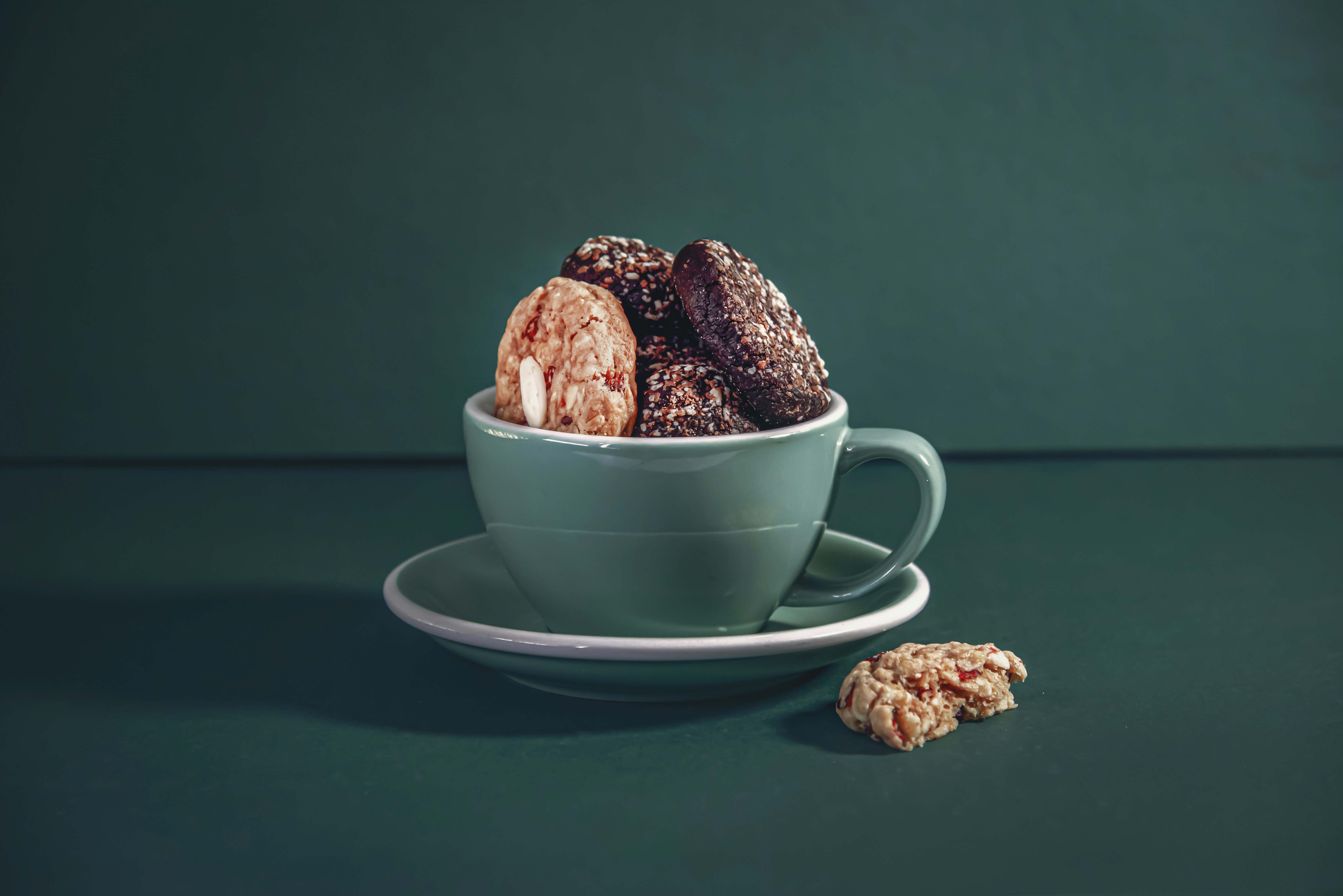 A cup filled with cookies sitting on top of a saucer