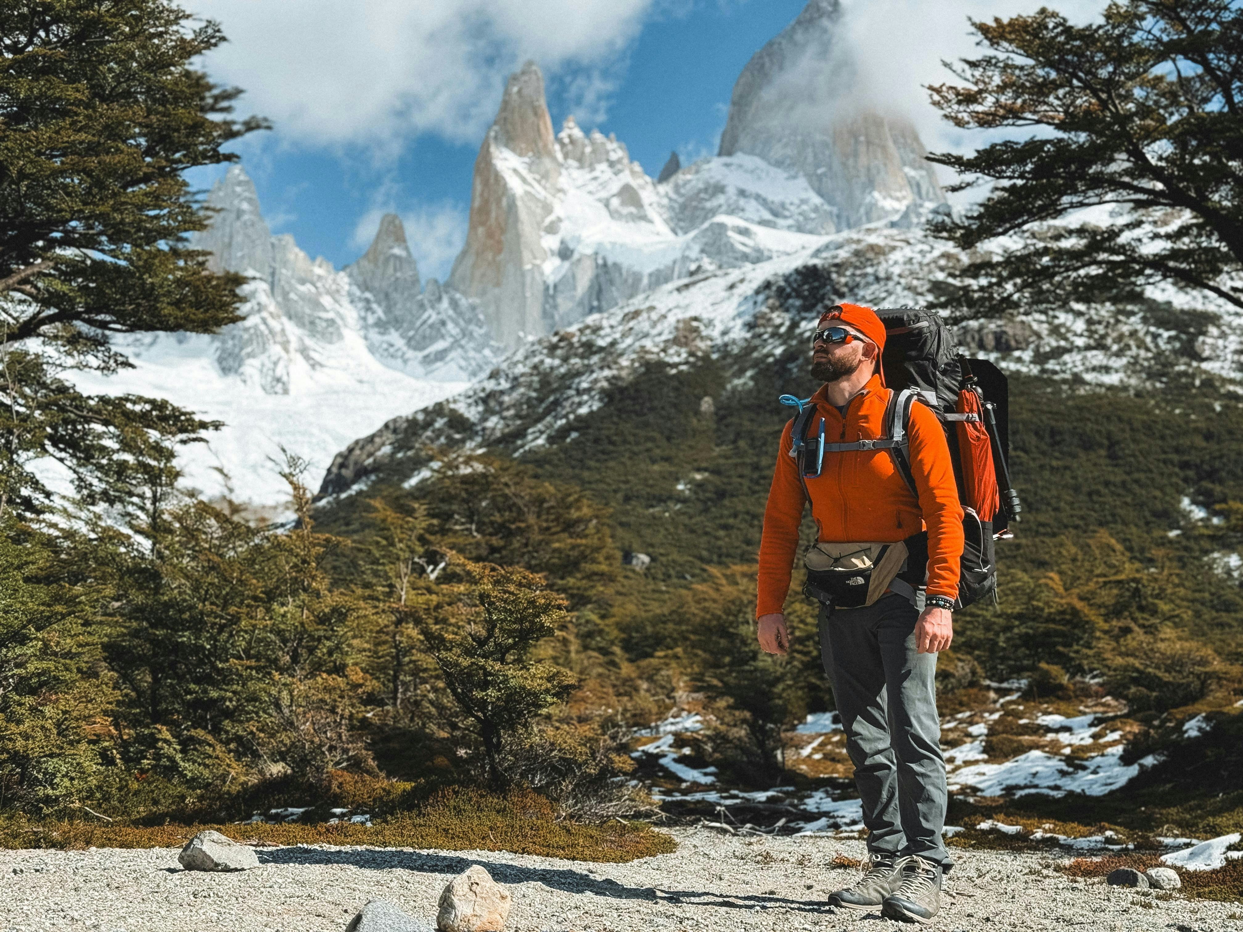 A man with a backpack is hiking in the mountains