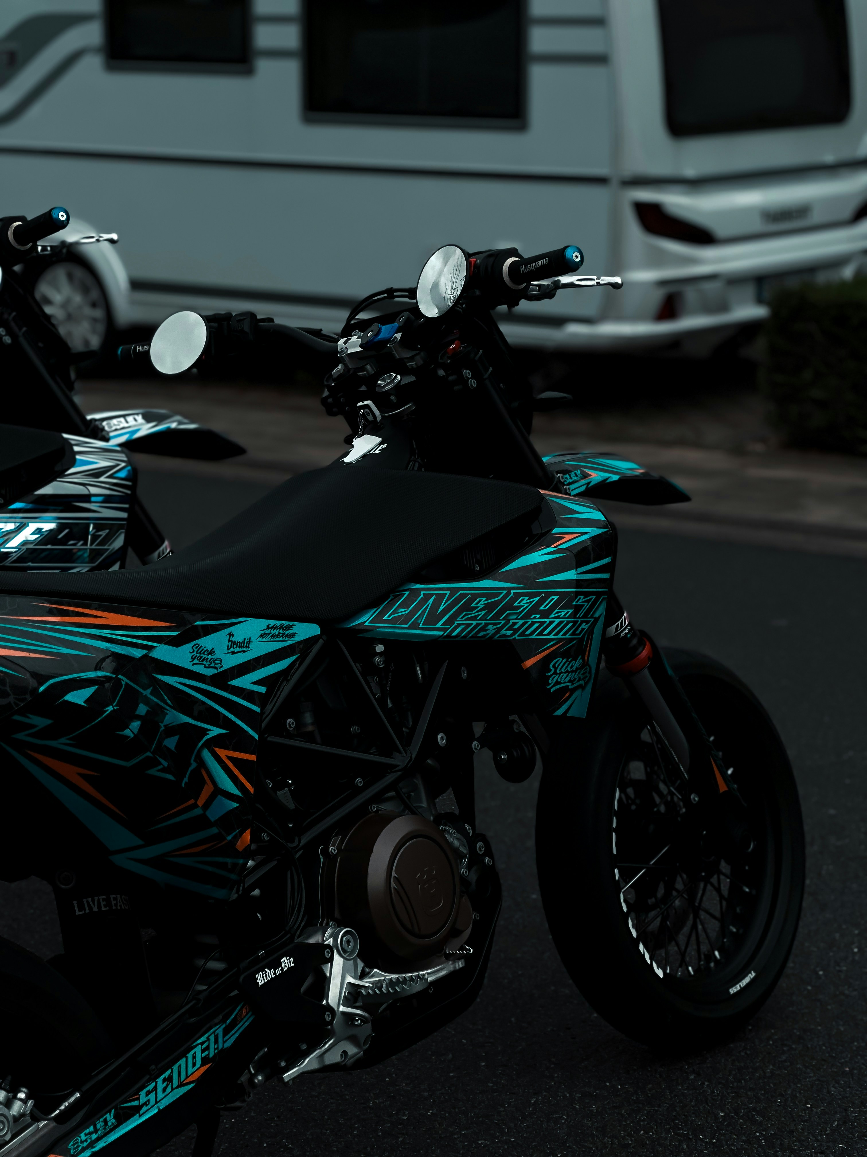 A motorcycle parked in a parking lot next to a motor home