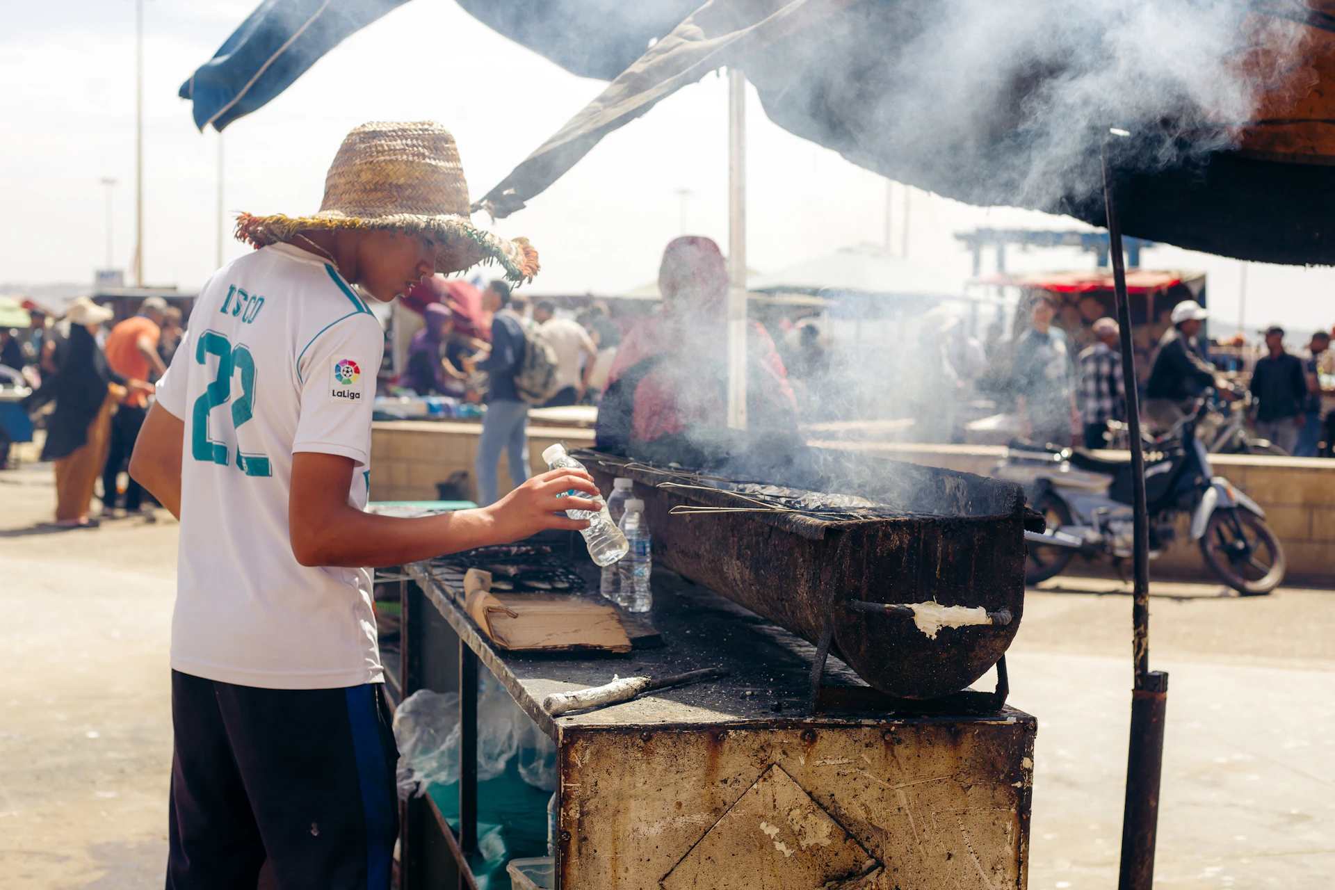 A man cooking food on a grill outside