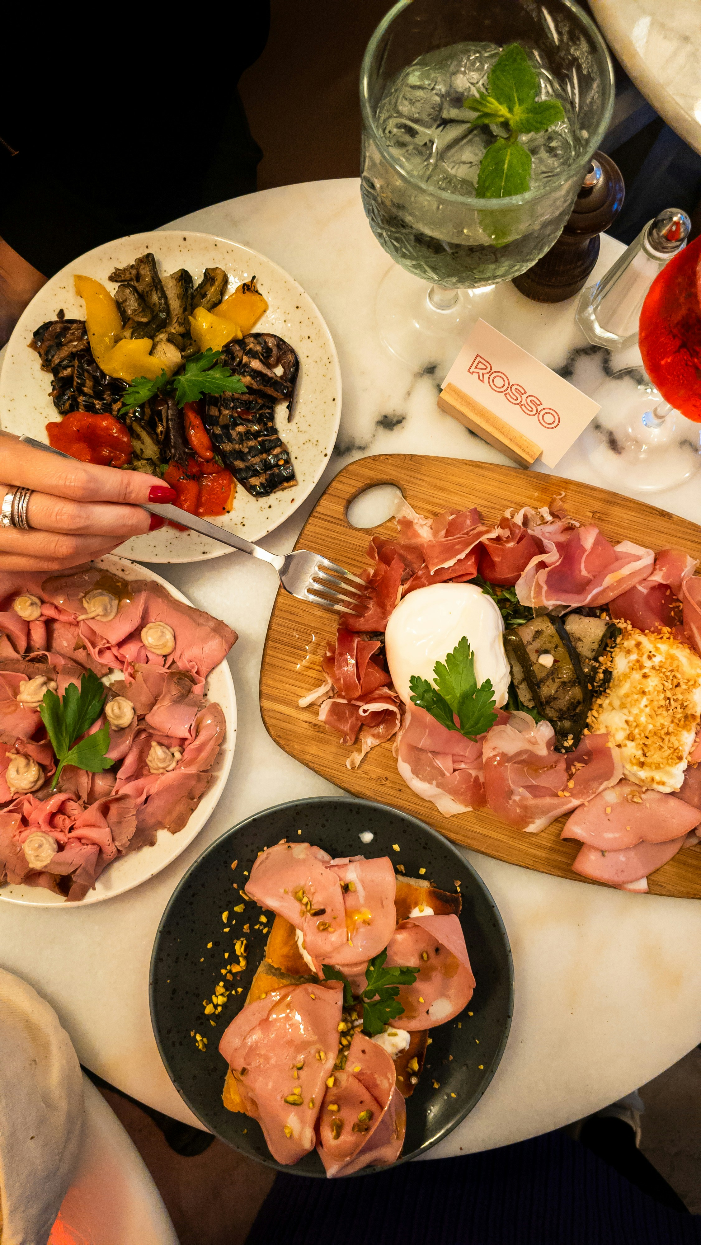 A table topped with plates of food and drinks