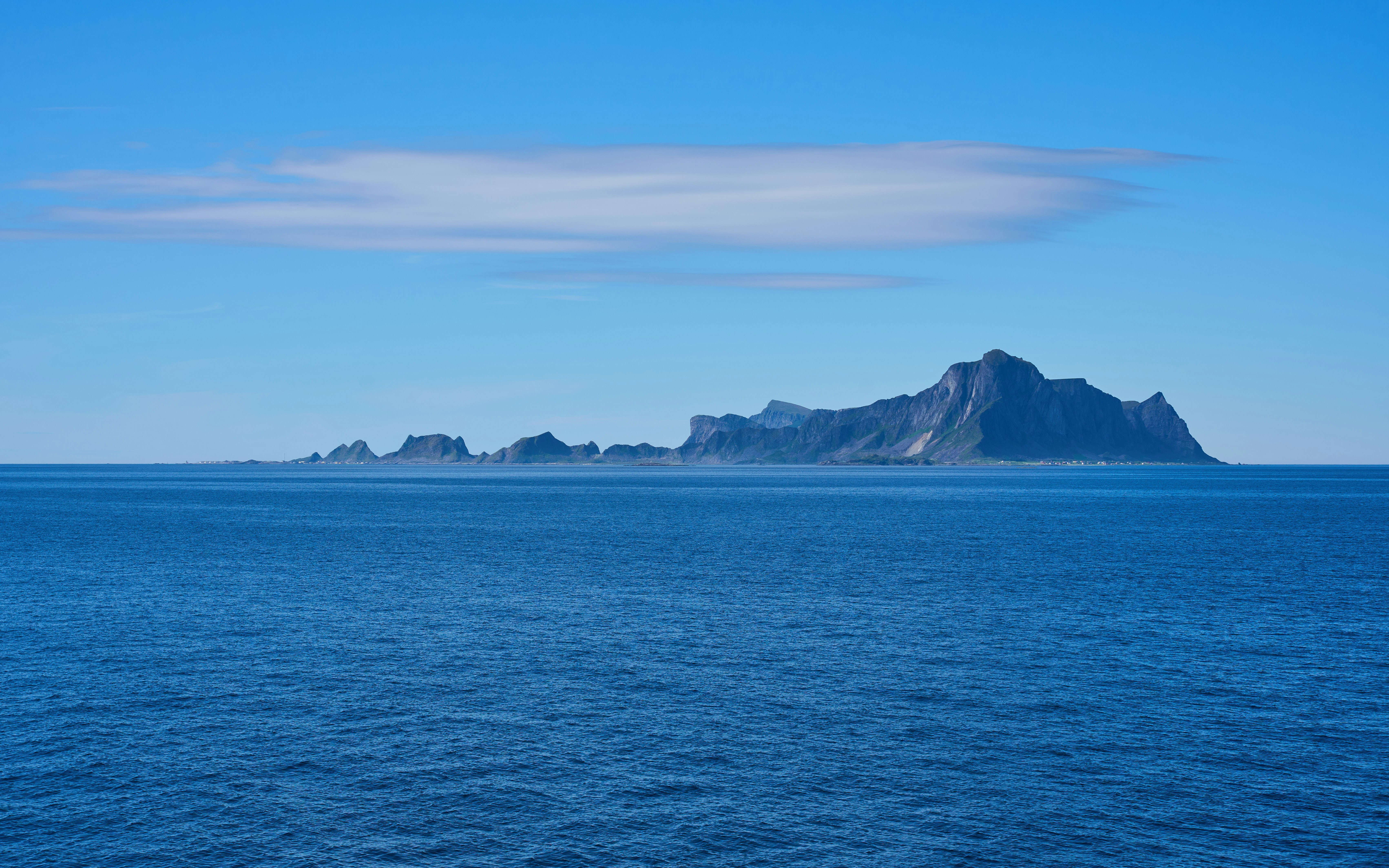 A large body of water with a small island in the distance