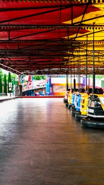 A row of bumper cars parked under a covered area
