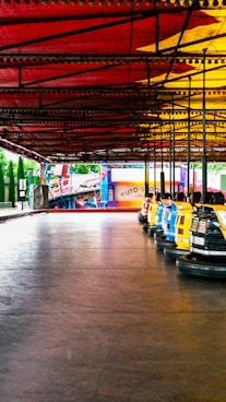 A row of bumper cars parked under a covered area