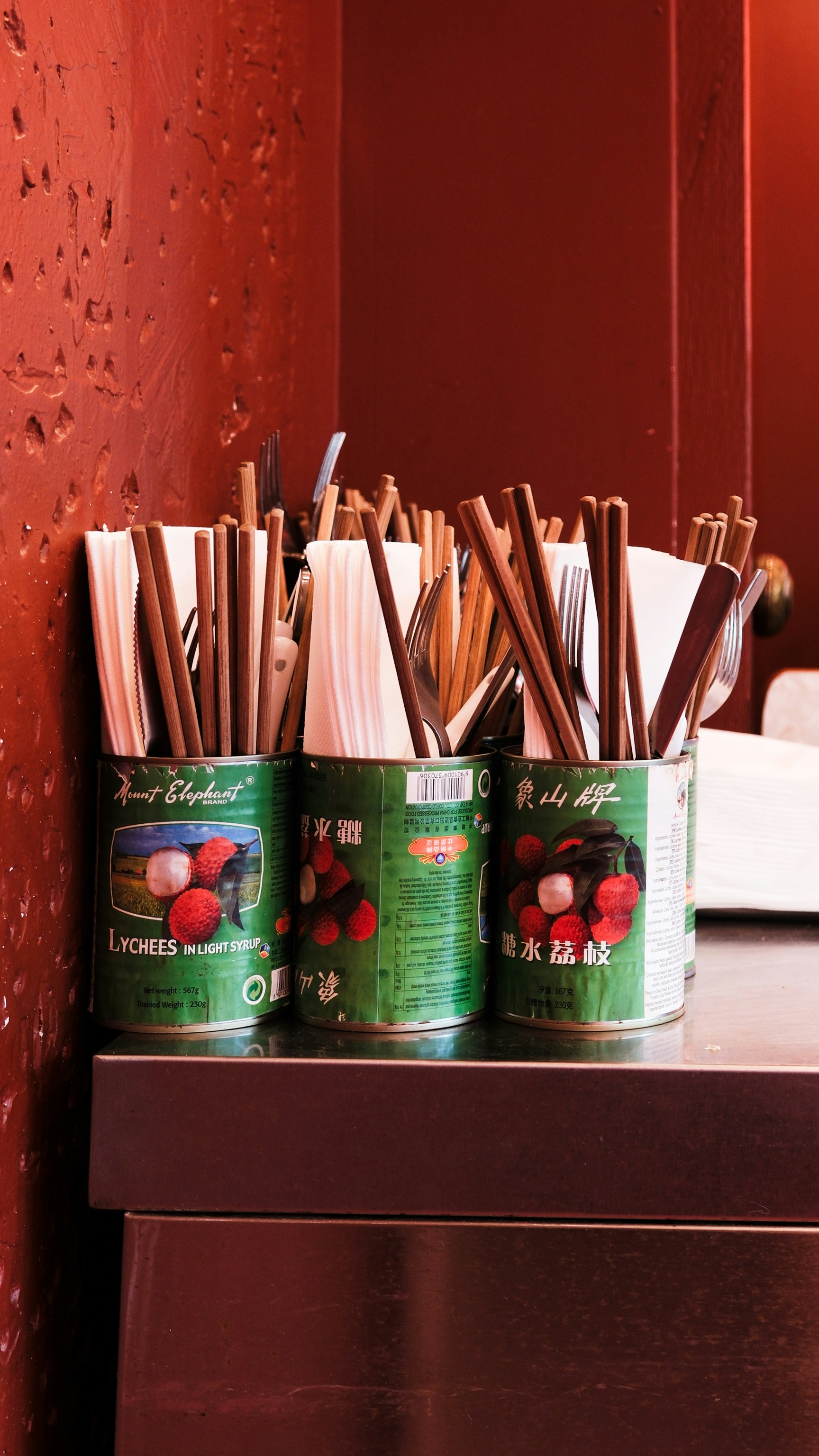 Four cans of tea sit on a table