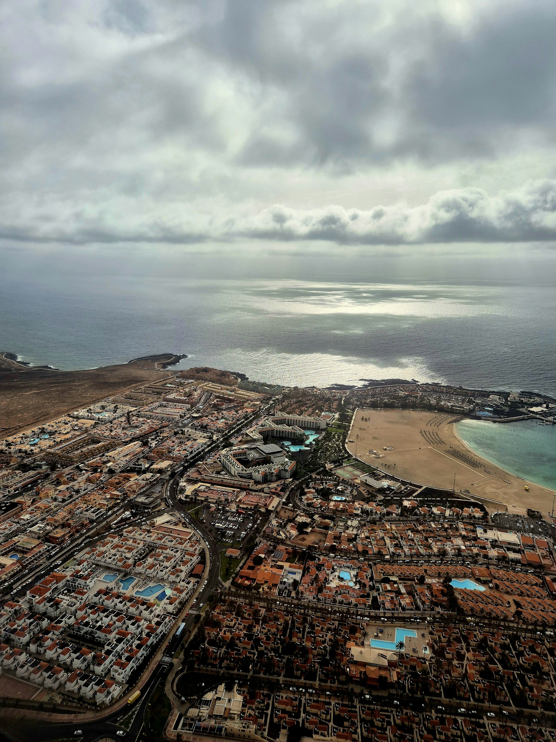 An aerial view of a city and the ocean
