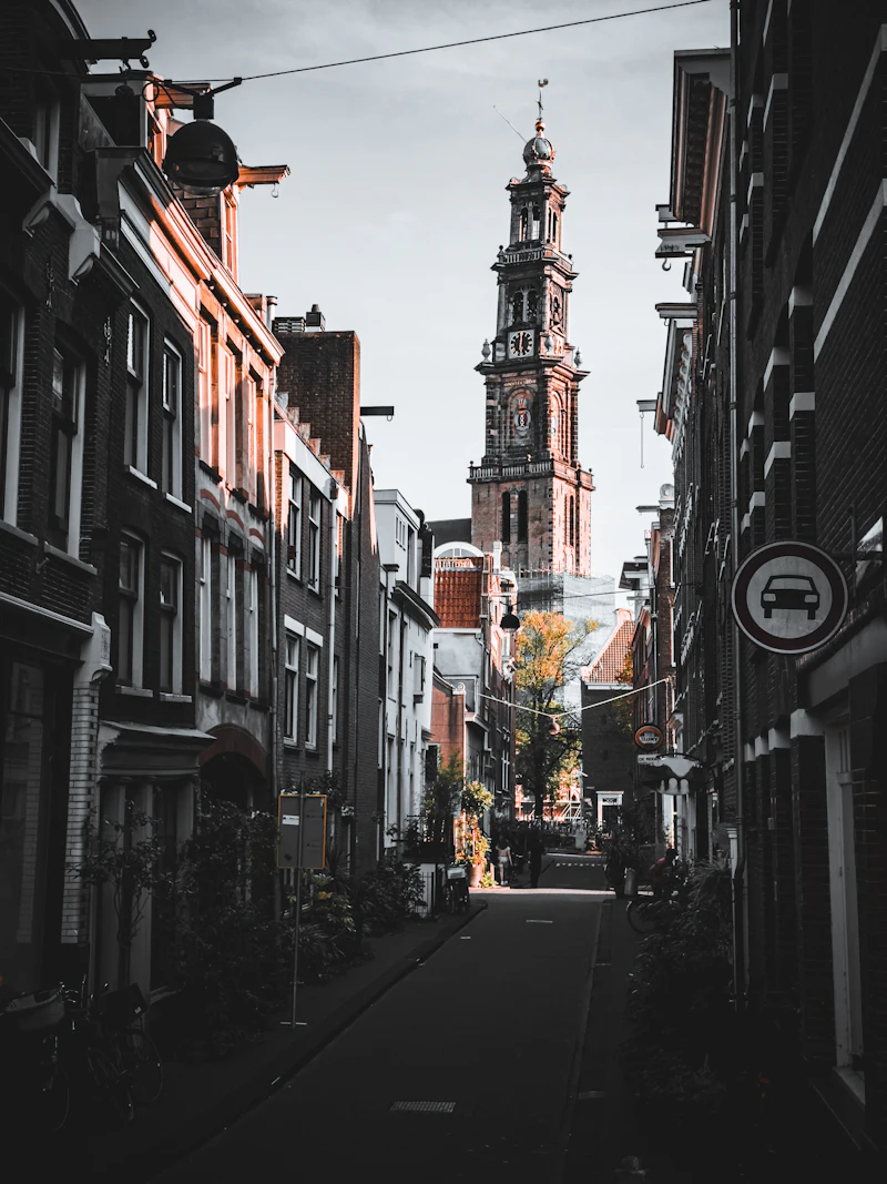 Narrow Jordaan street with a church steeple