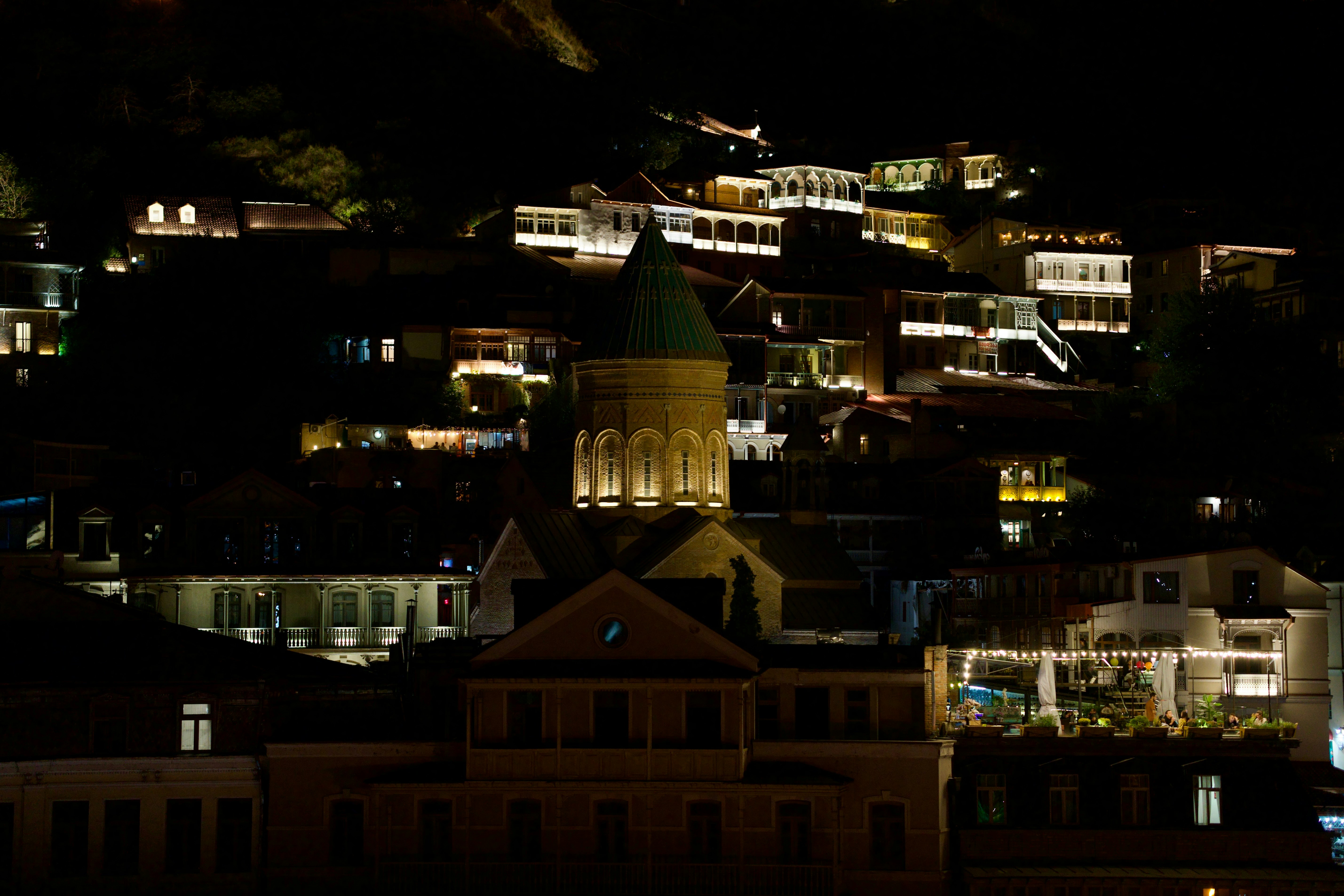 A night view of a city with a clock tower