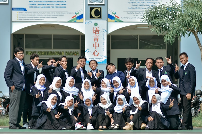 A group of people posing for a picture in front of a building