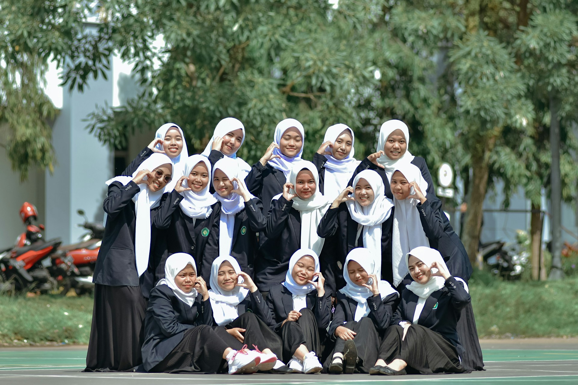 A group of women in black dresses posing for a picture