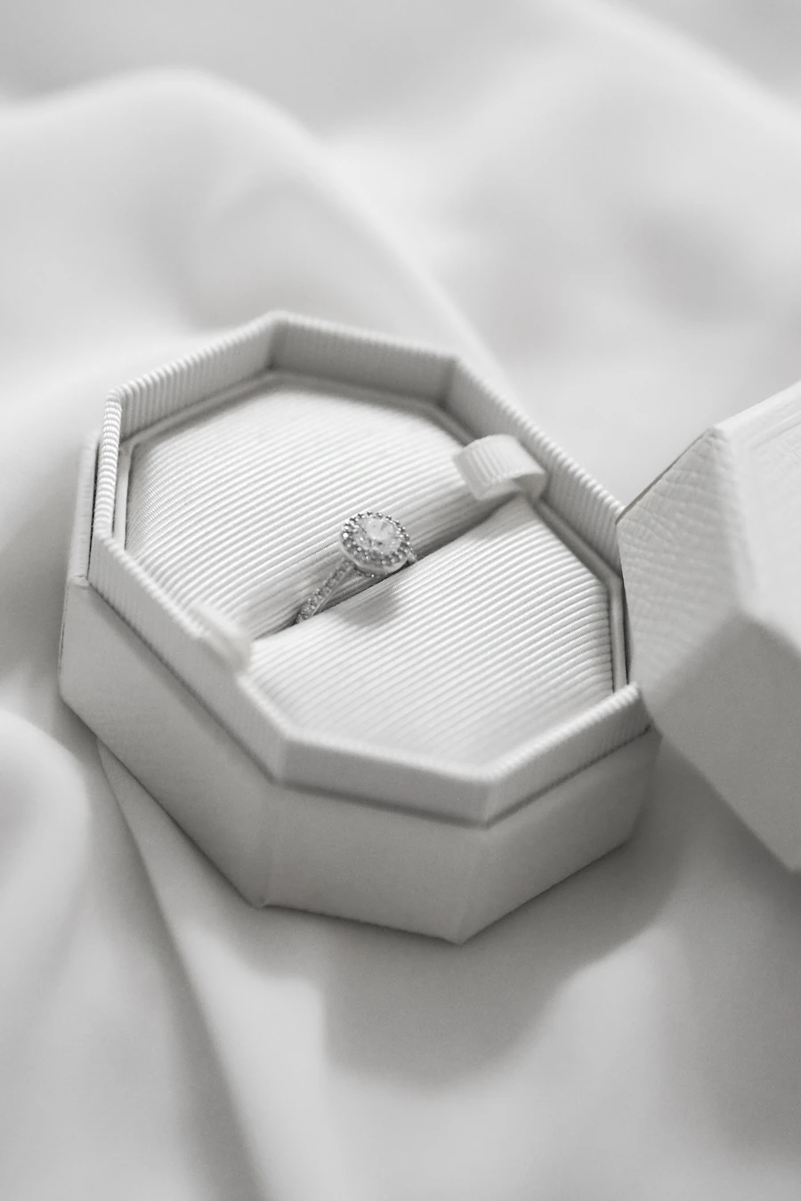 Diamond halo ring in a white velvet box