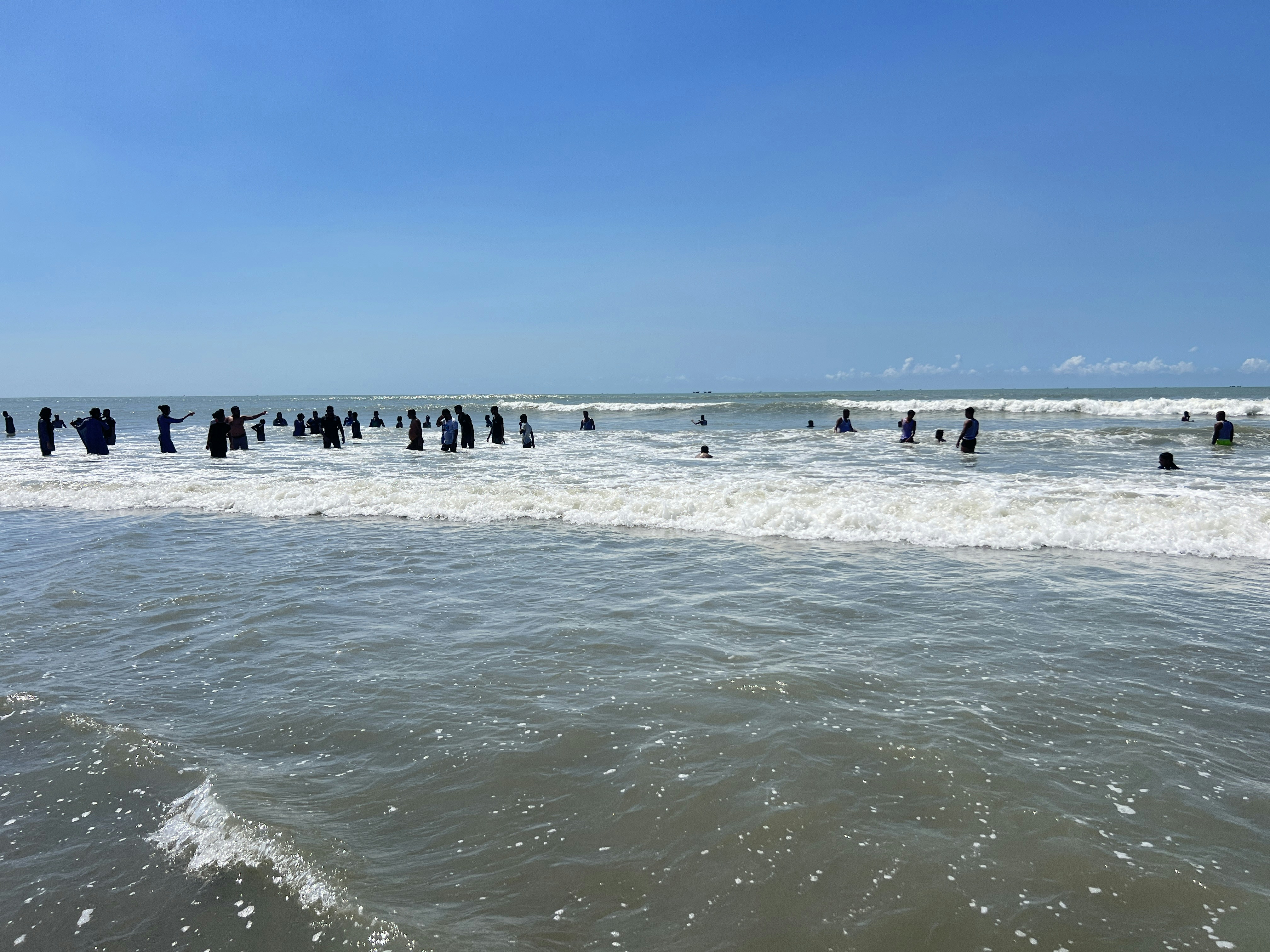 A group of people standing in the ocean photo – Free Laboni beach Image ...