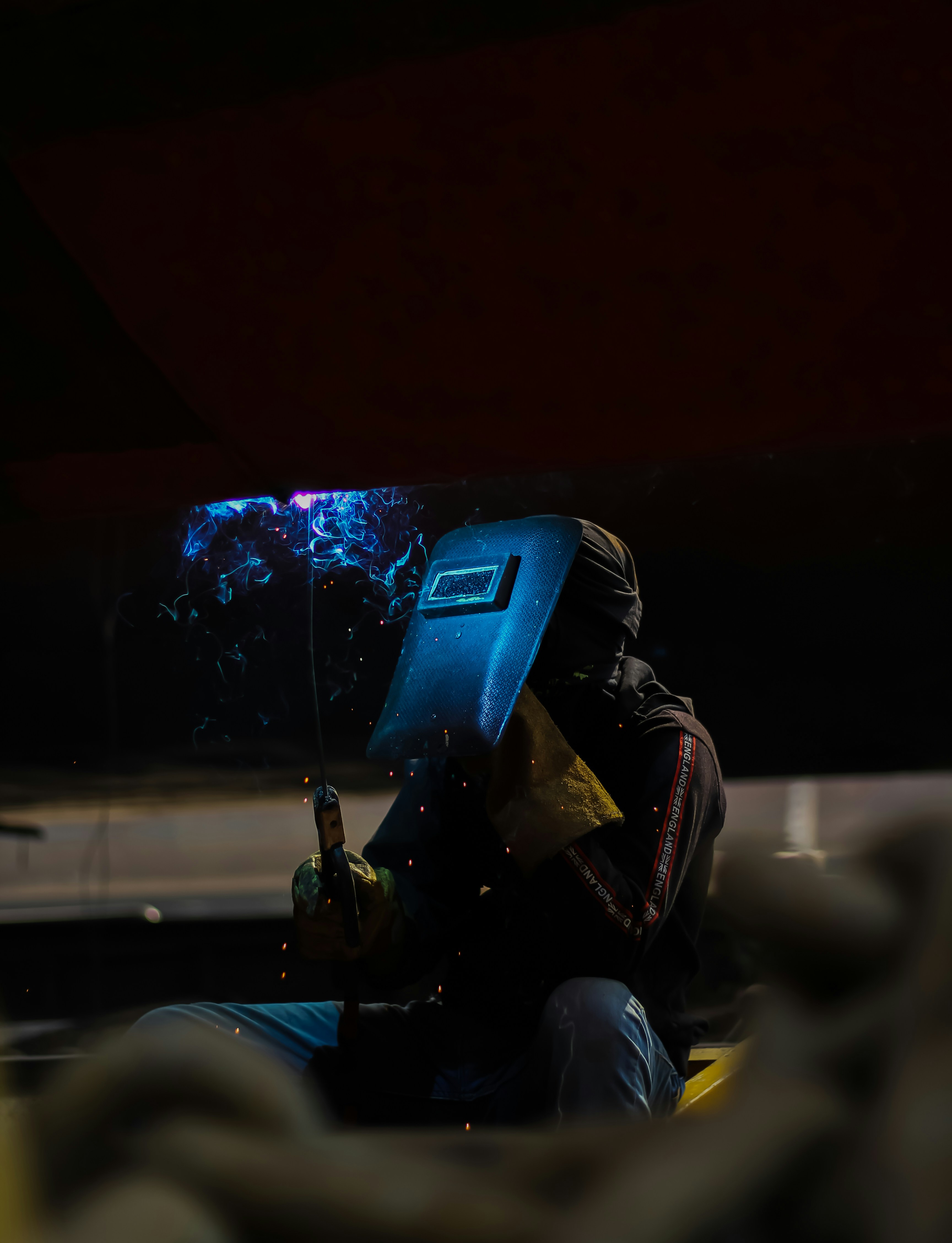 A man sitting in a chair with a cell phone in his hand