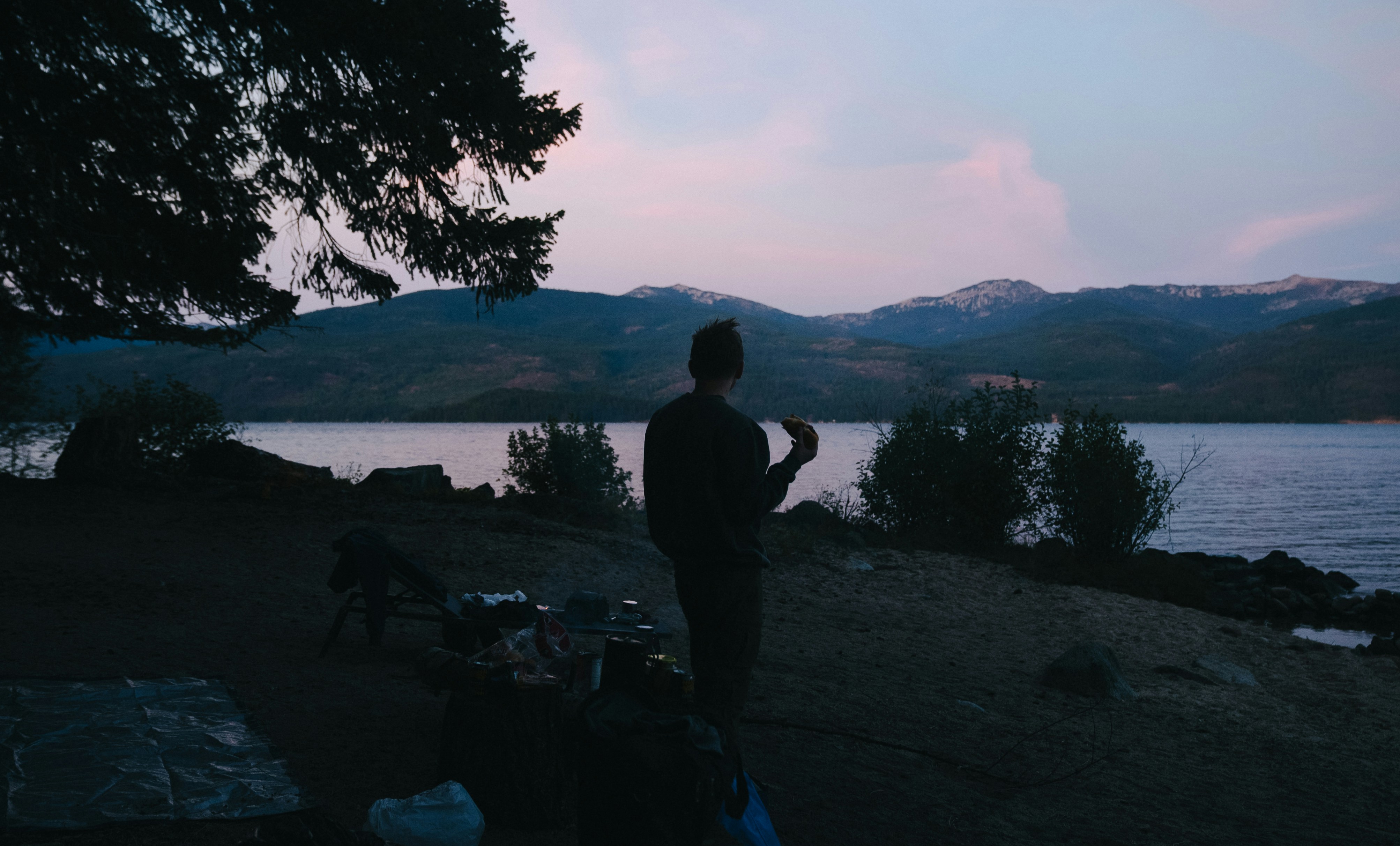 A man standing next to a body of water
