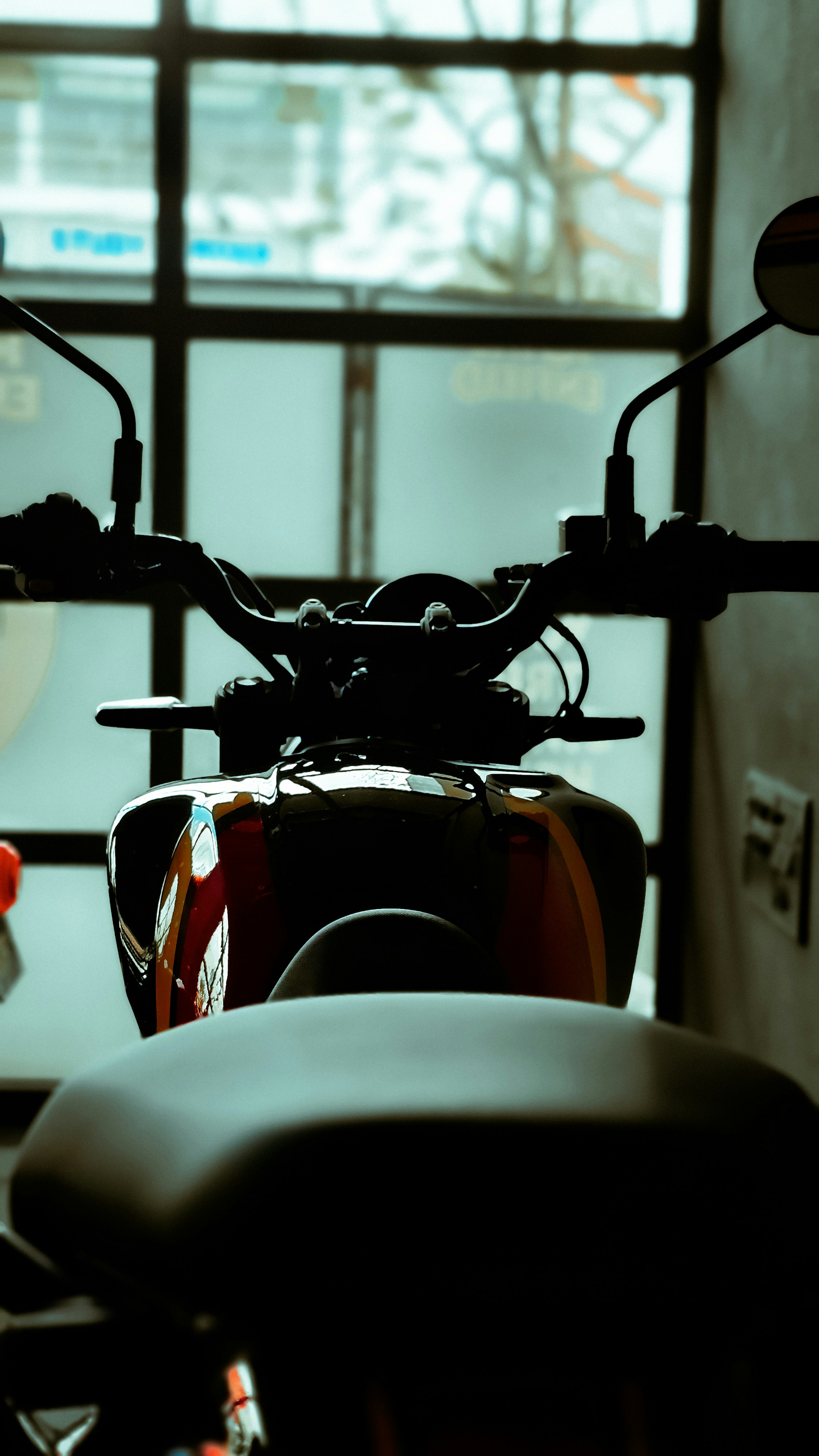 A motorcycle parked in front of a window