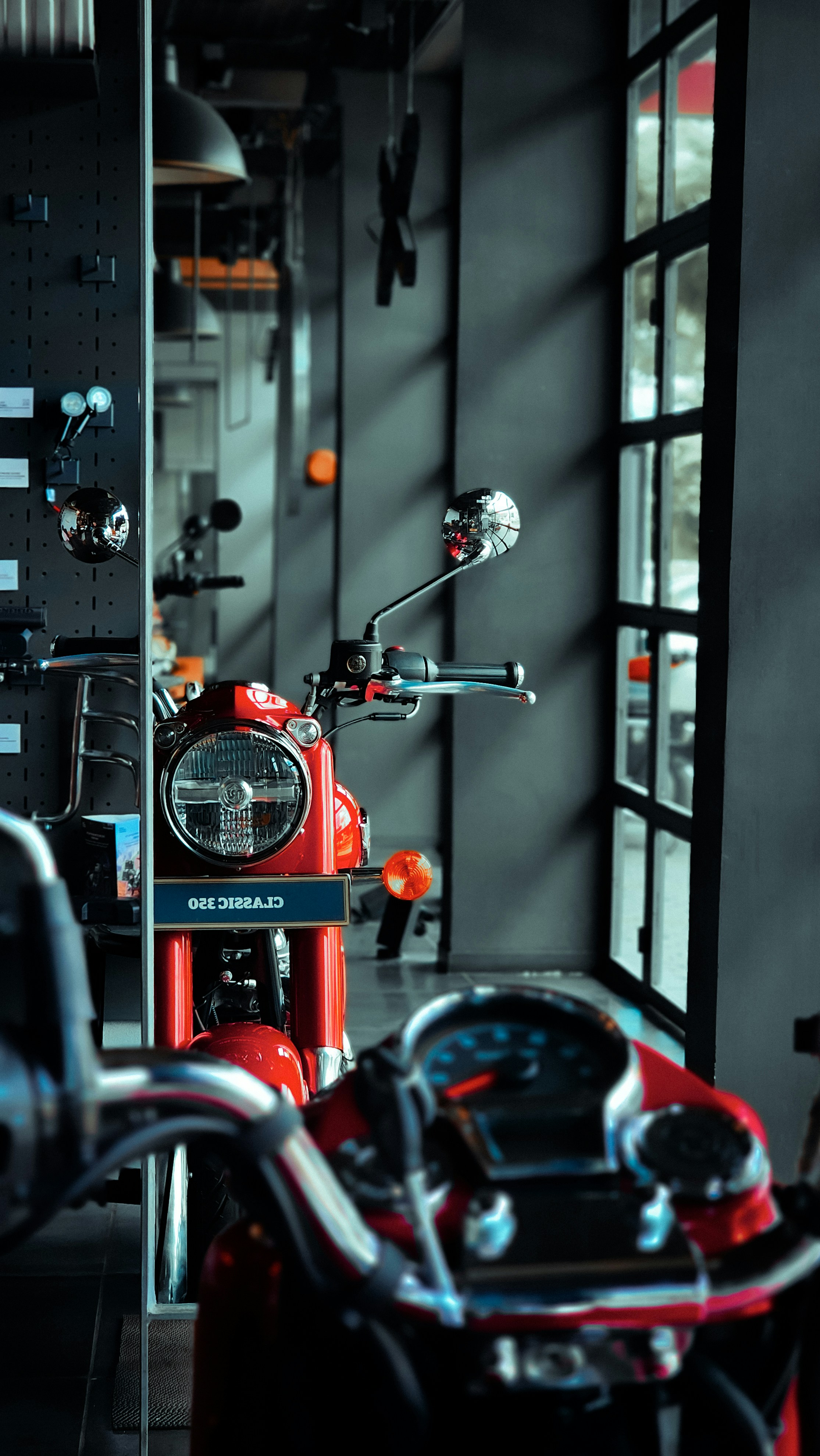 A red motorcycle parked inside of a garage