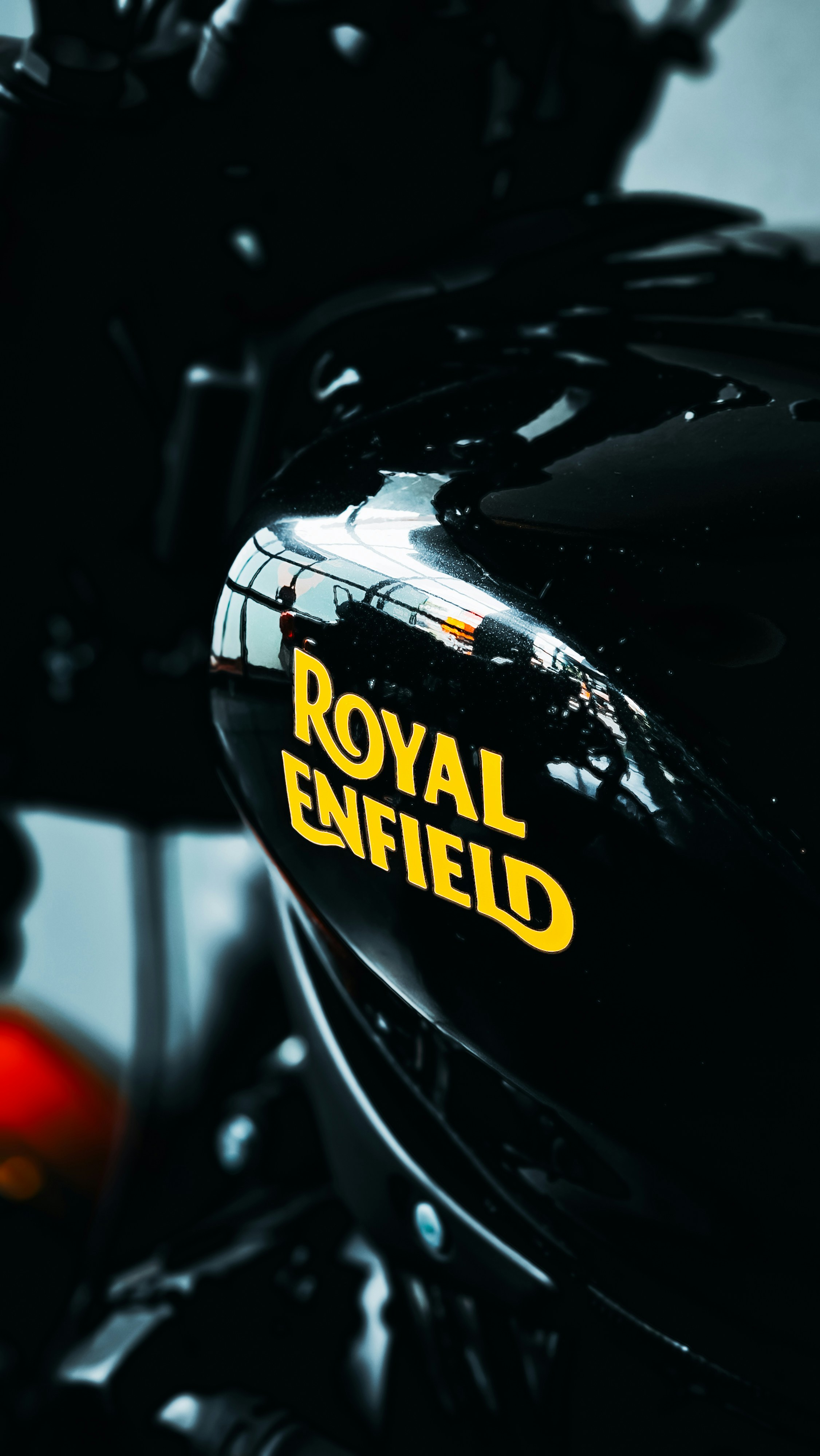 A black motorcycle with a yellow royal enfield sticker on it