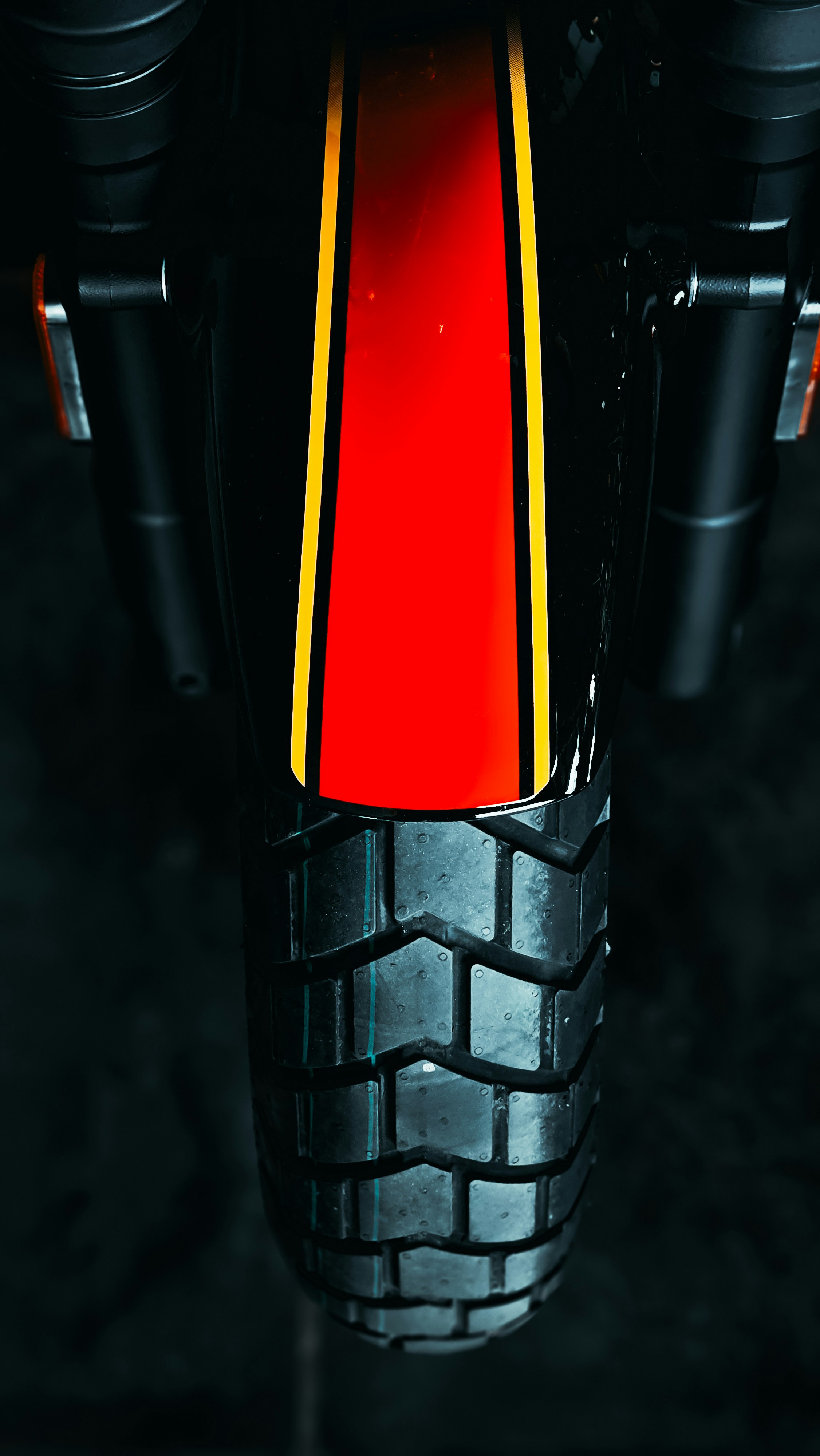 A close up of a red and yellow motorcycle tire