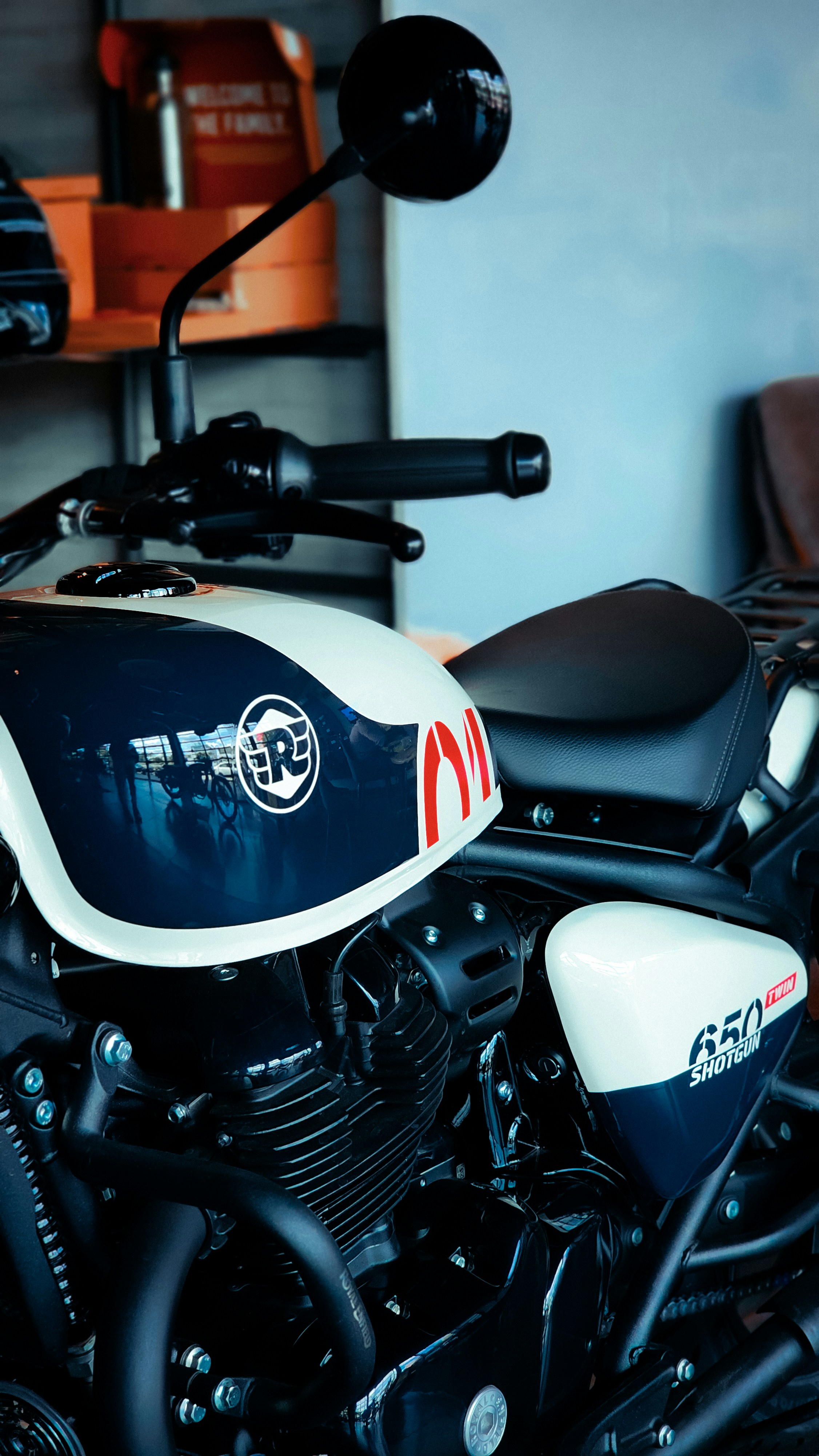 A white and blue motorcycle parked in a garage