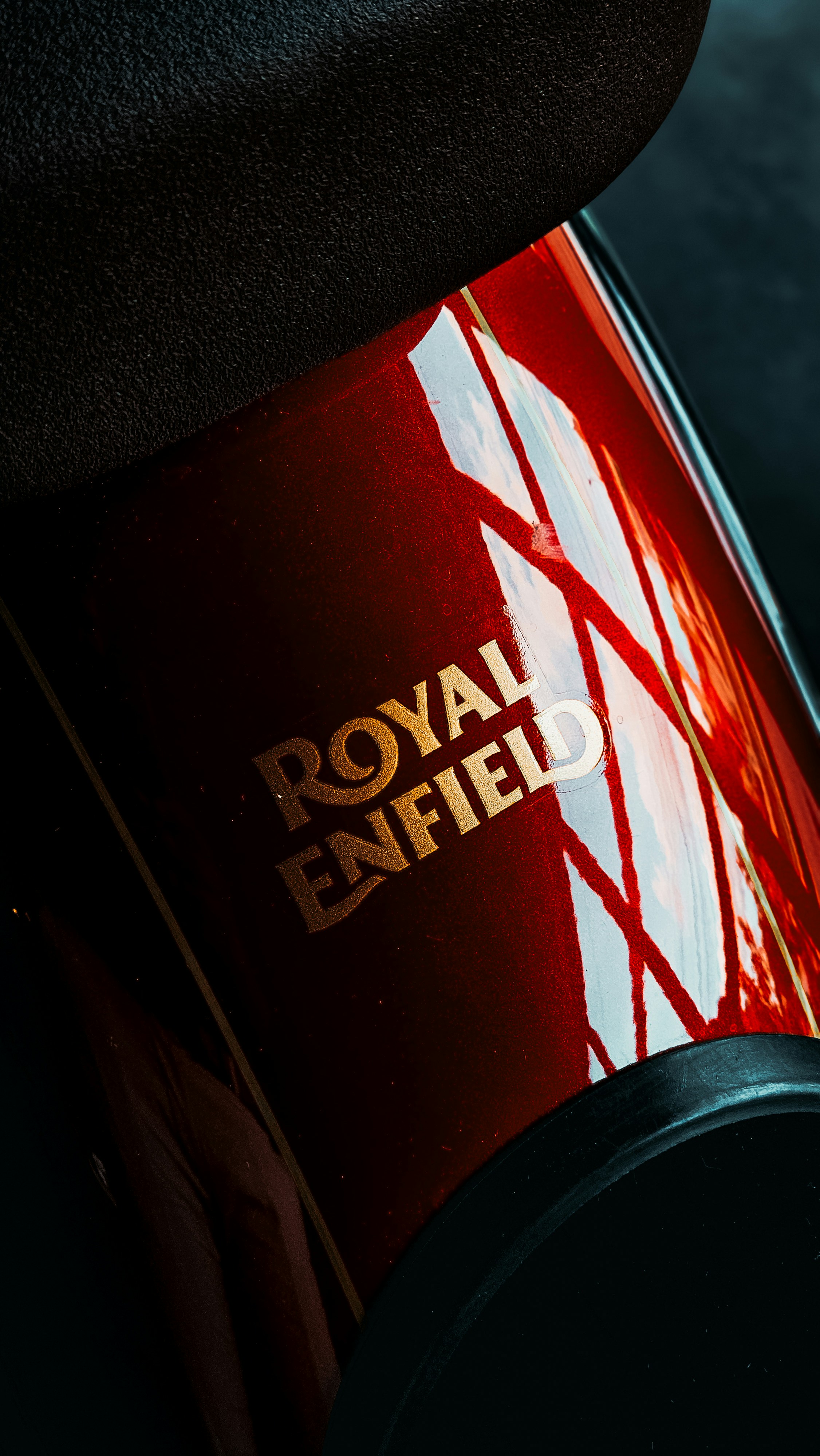 A close up of a red car with the royal enfield logo on it