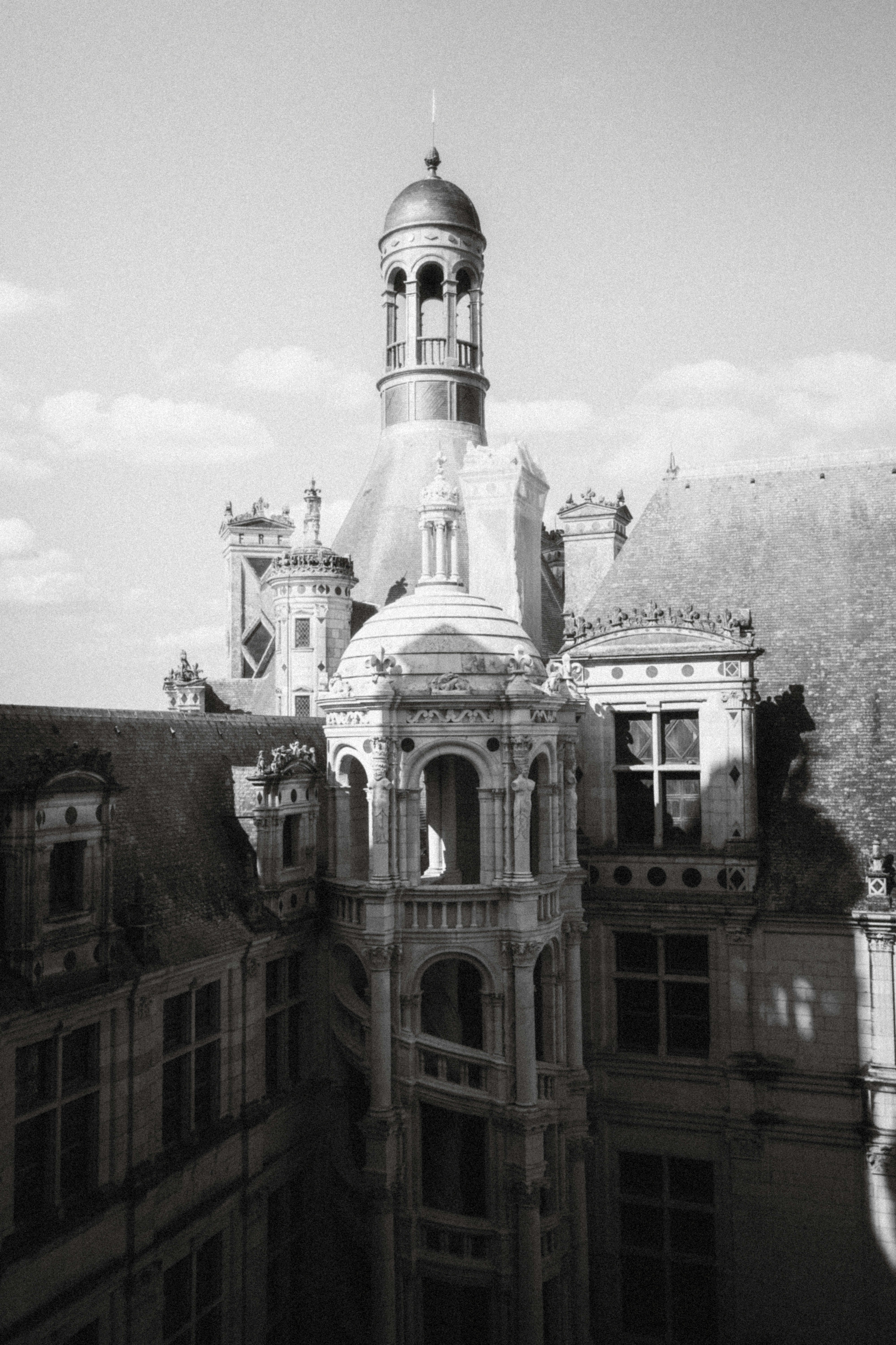 A black and white photo of a building with a clock tower