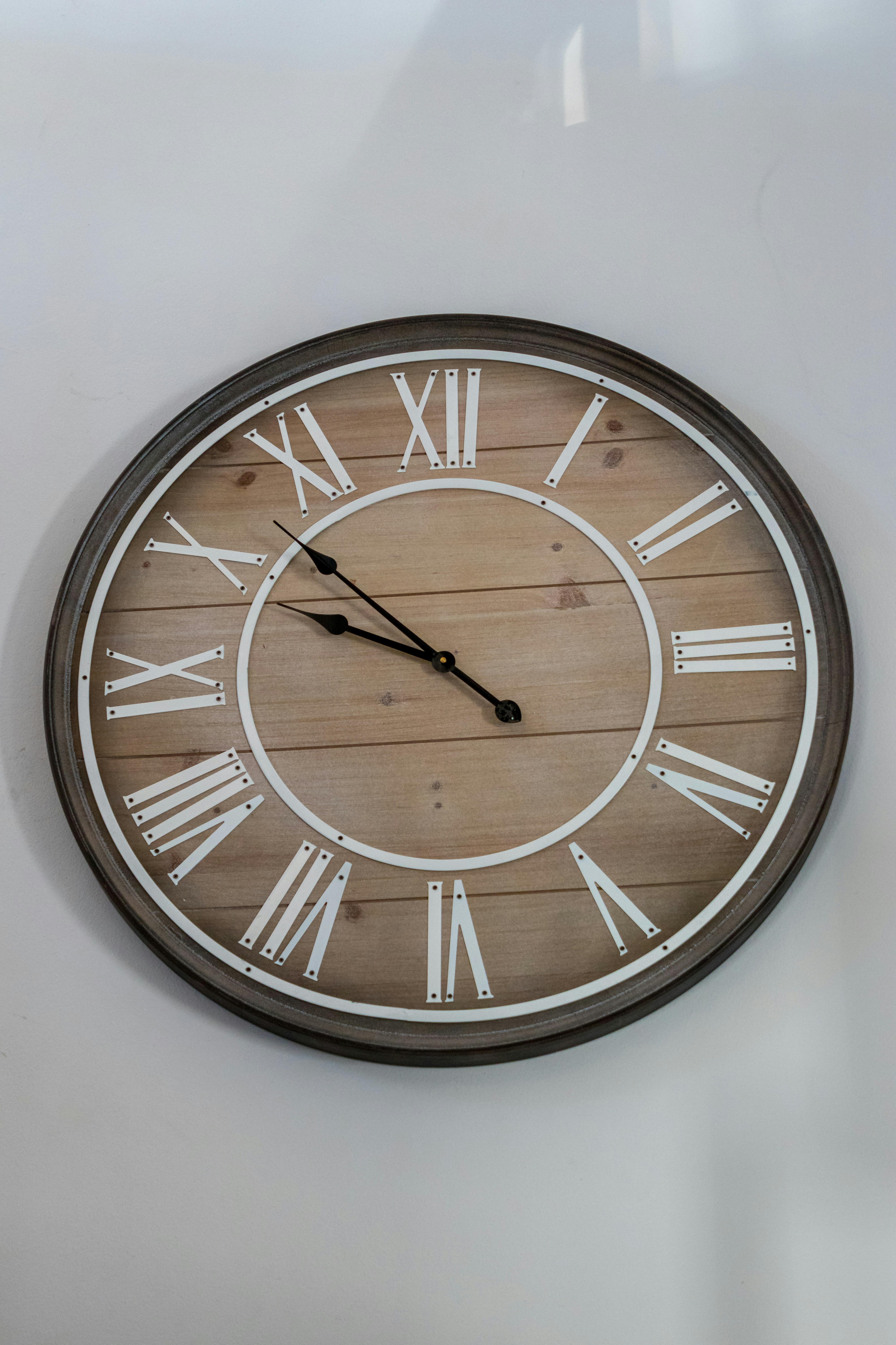 A clock on a wall with roman numerals