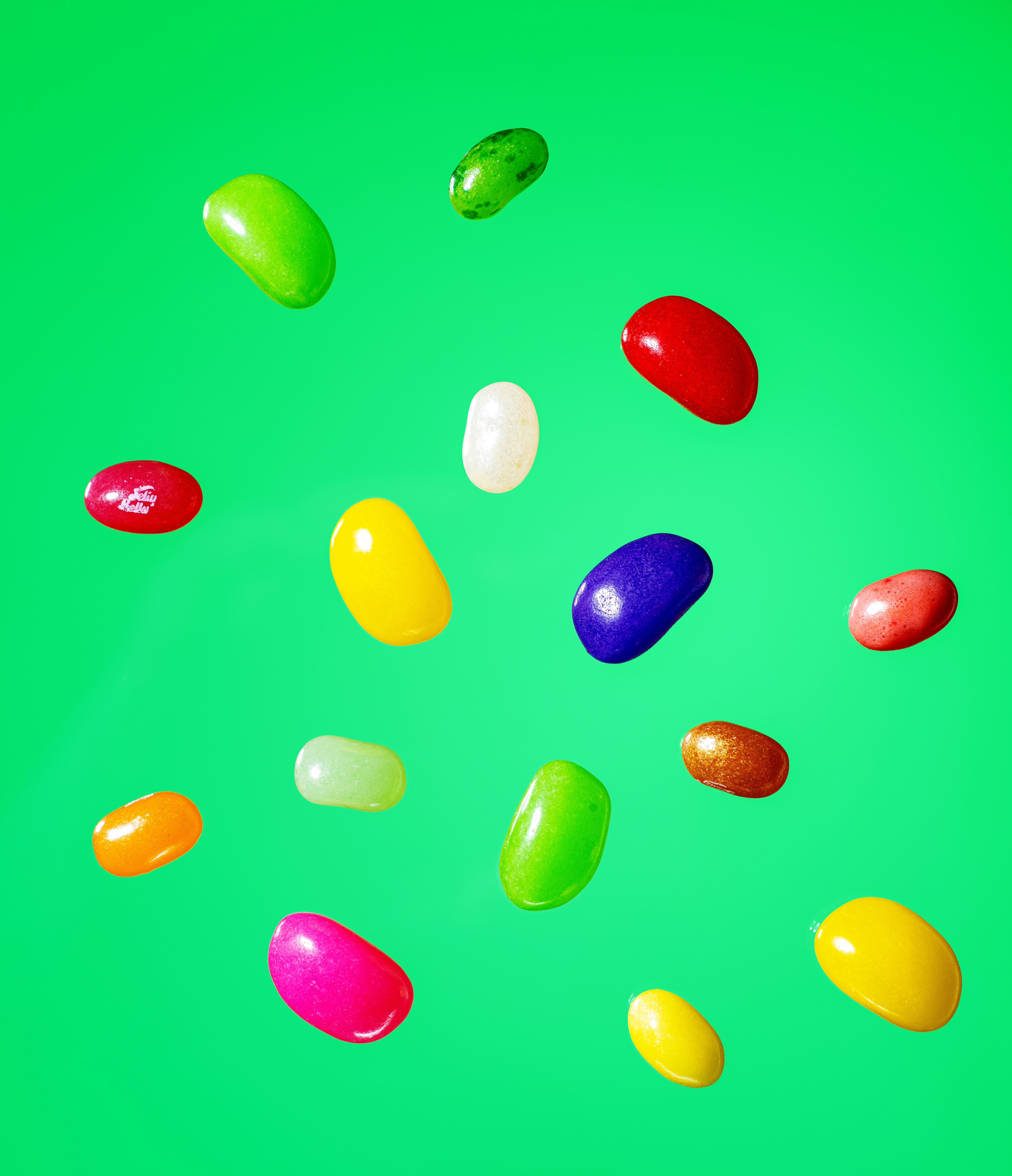 A bunch of jelly beans on a green background