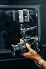 A person holding a camera in front of a mirror