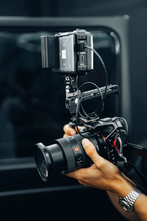A person holding a camera in front of a mirror