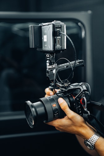 A person holding a camera in front of a mirror