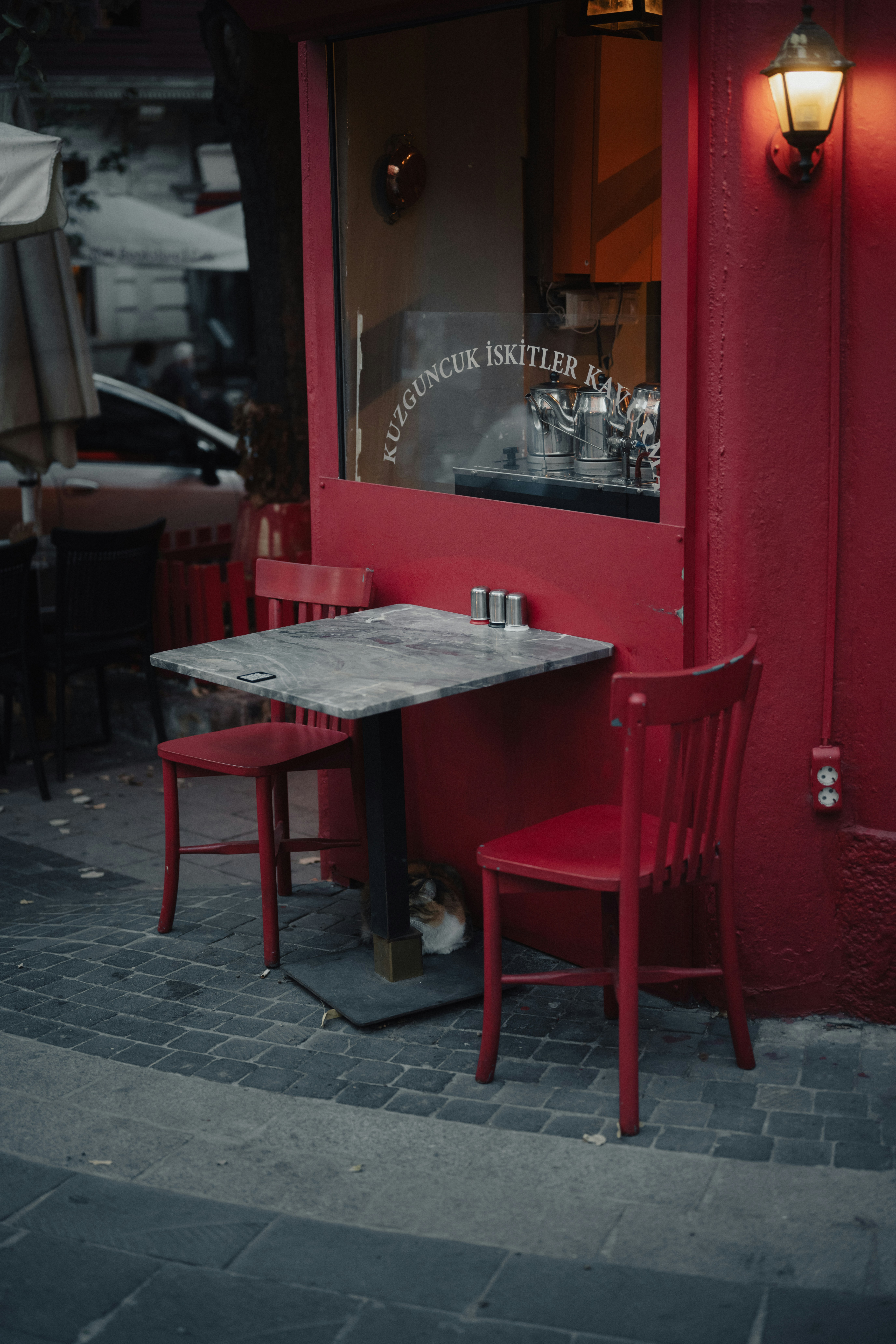 A red table and chairs outside of a restaurant