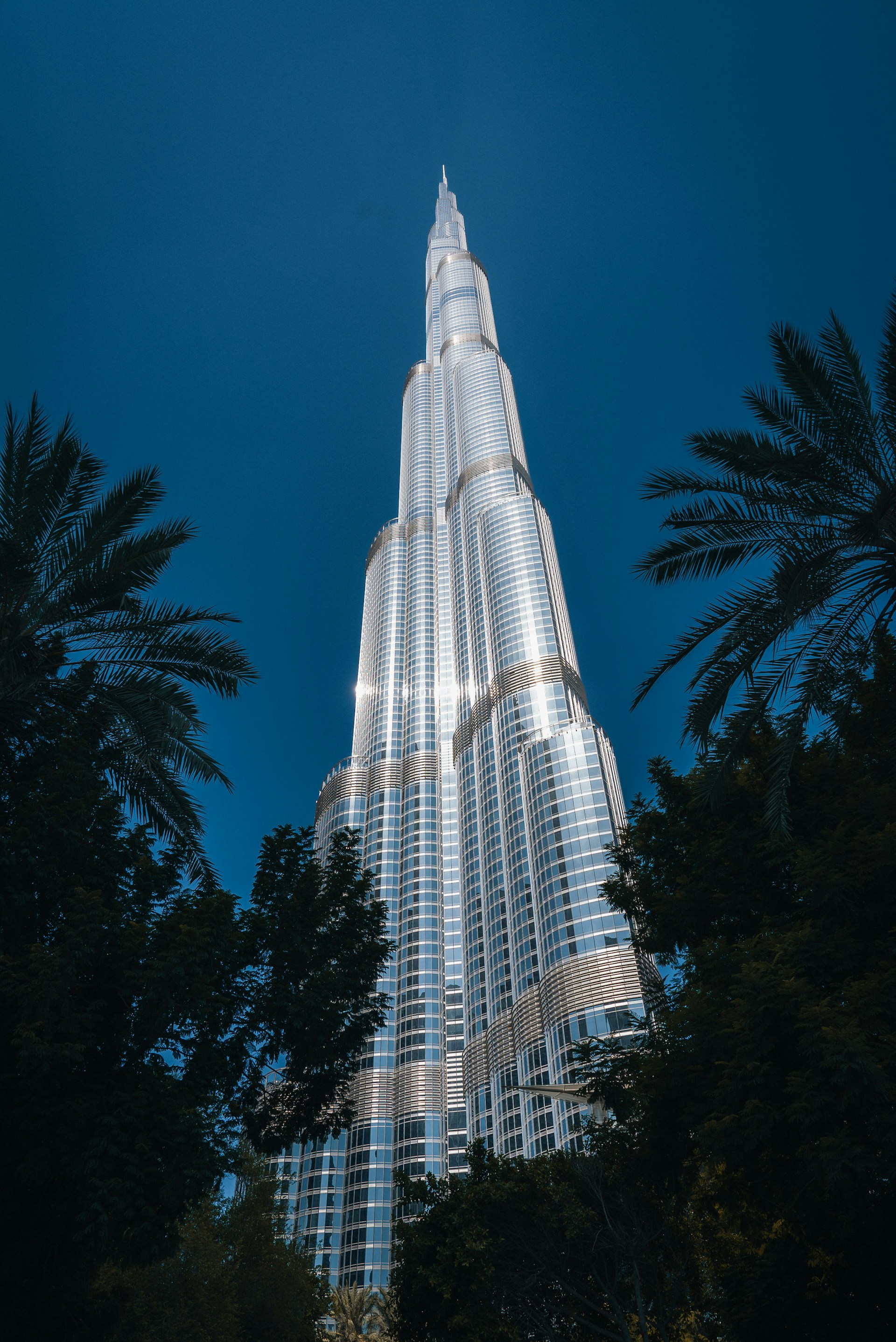 The burj building is lit up at night