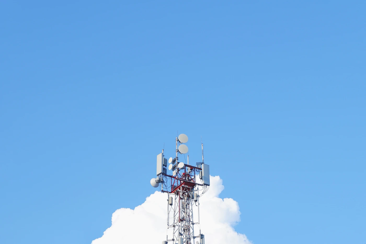 Cell phone tower against blue sky
