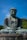 A large buddha statue sitting in front of a forest