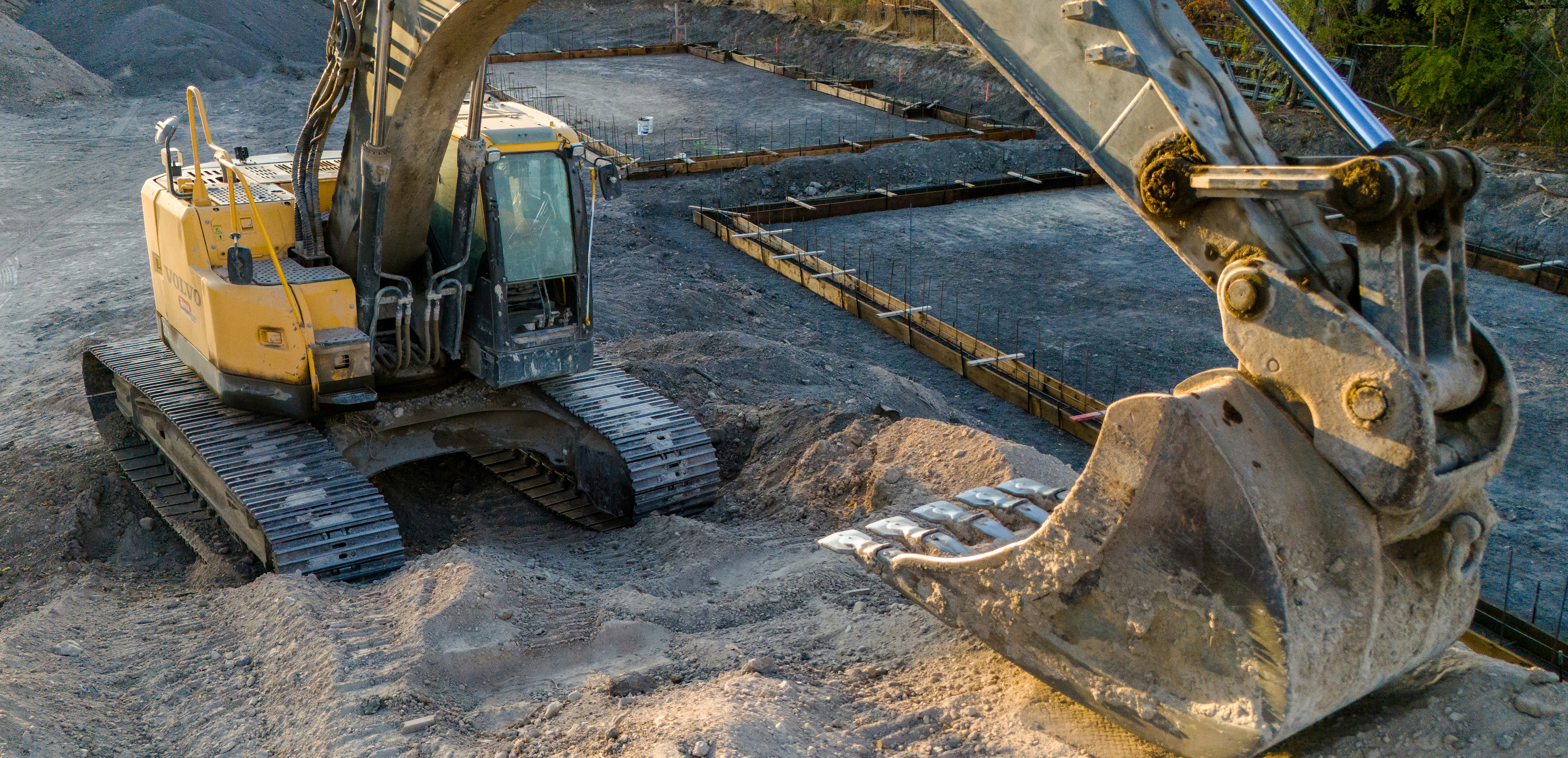 A small excavator sitting on top of a pile of dirt