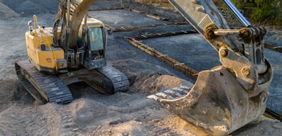 A small excavator sitting on top of a pile of dirt