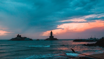 A view of the ocean with a lighthouse in the distance