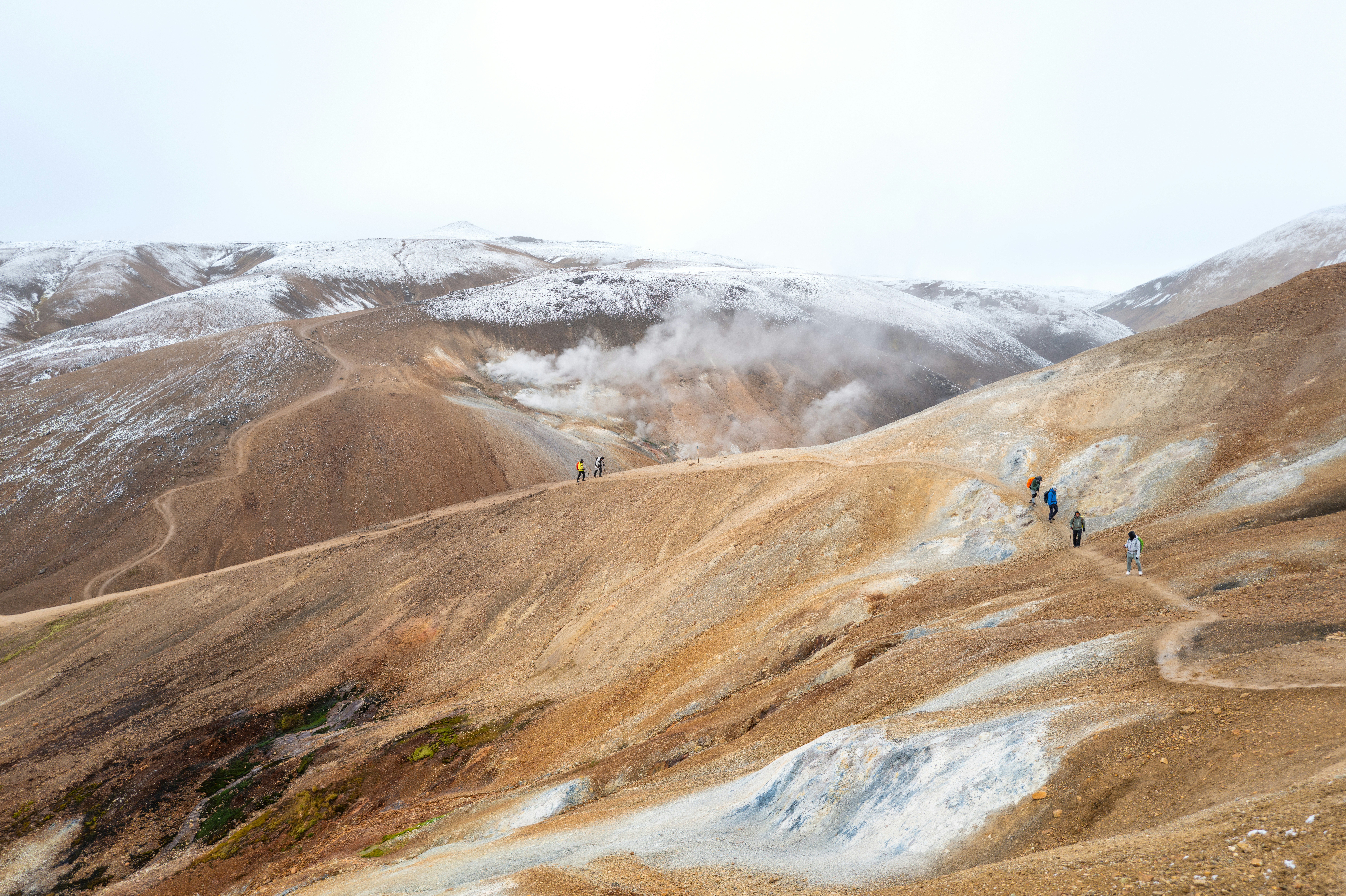 A group of people hiking up a mountain side