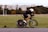 A man riding a bike down a street