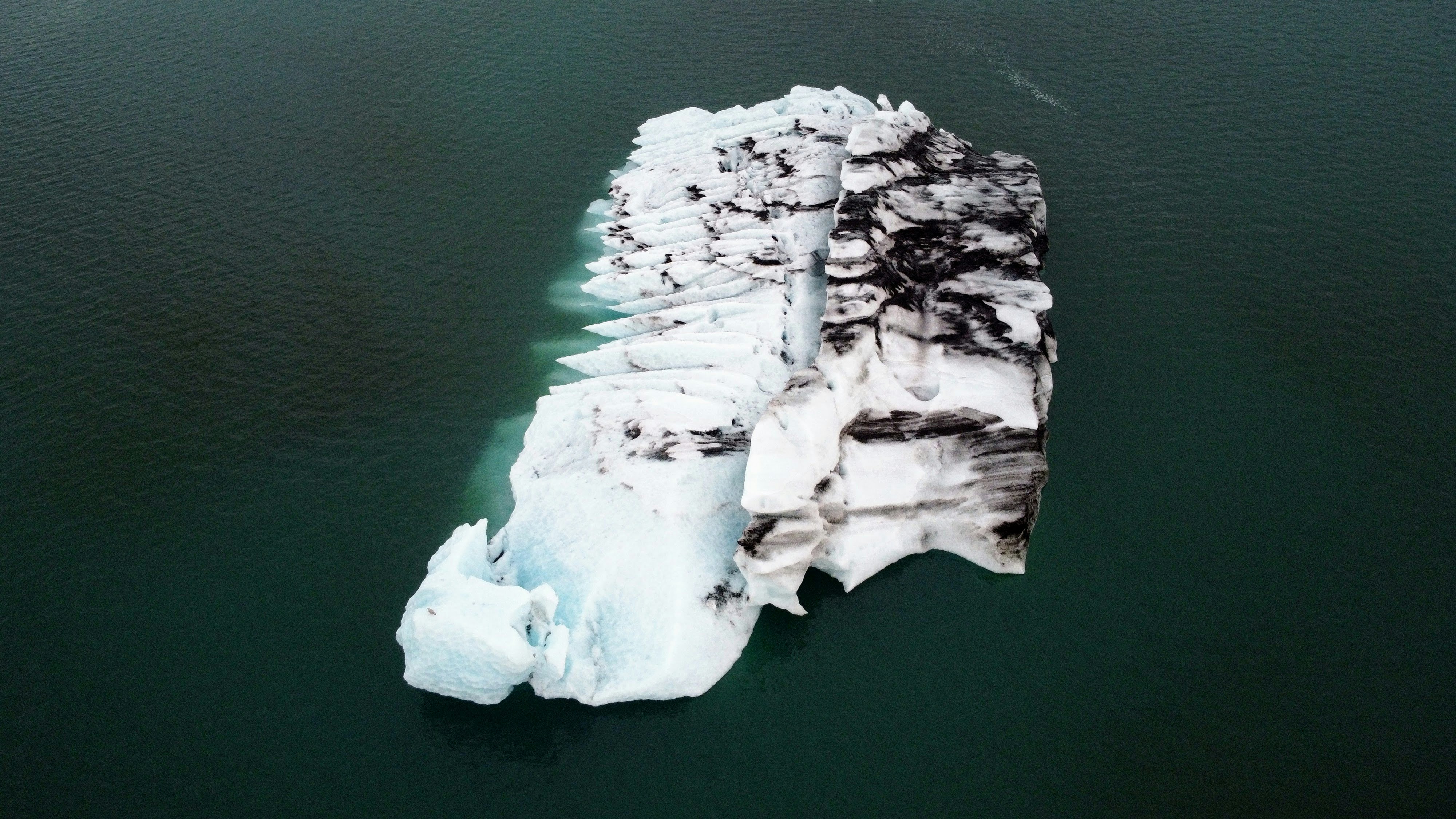 An iceberg floating in a body of water