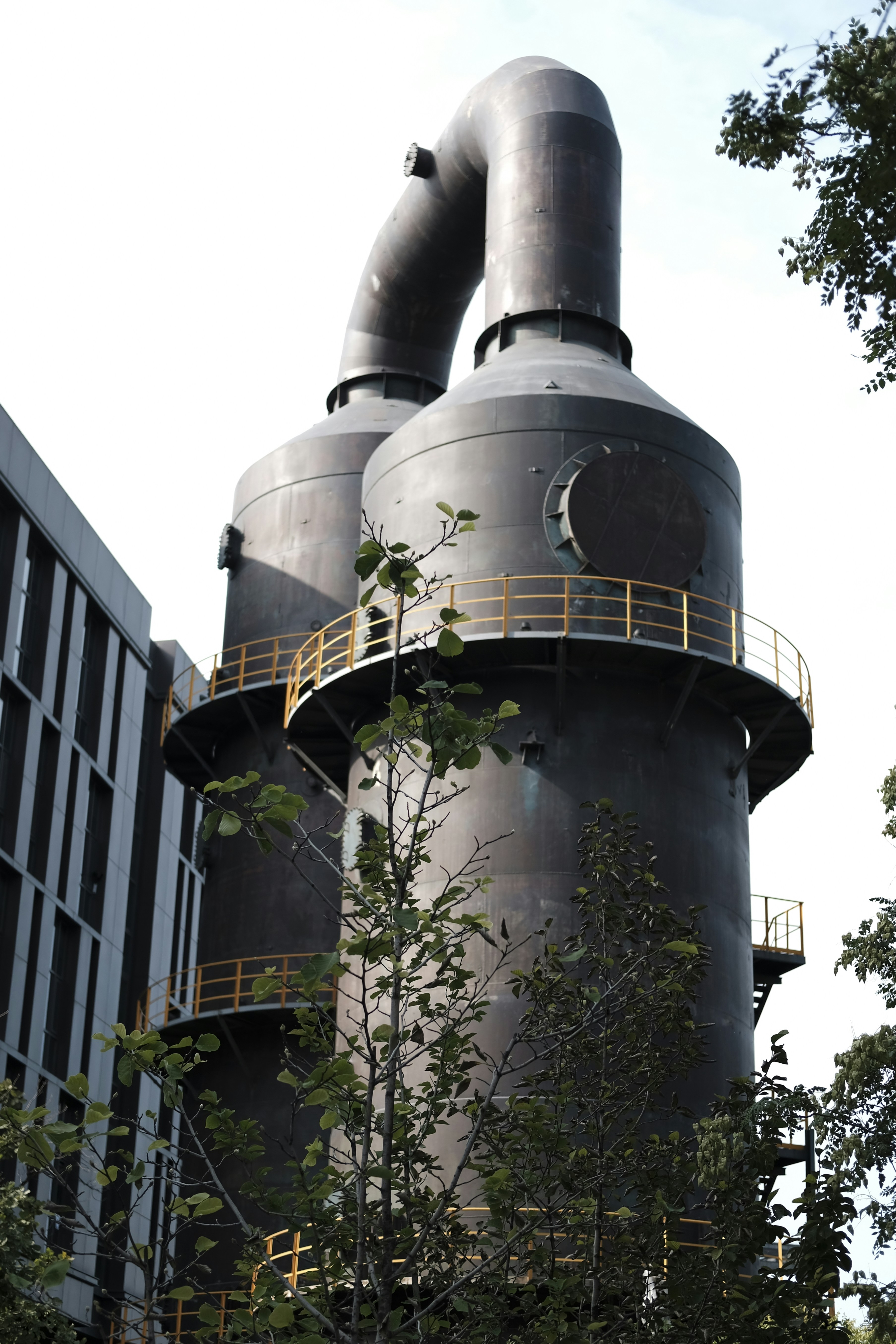 A large building with two large pipes on top of it